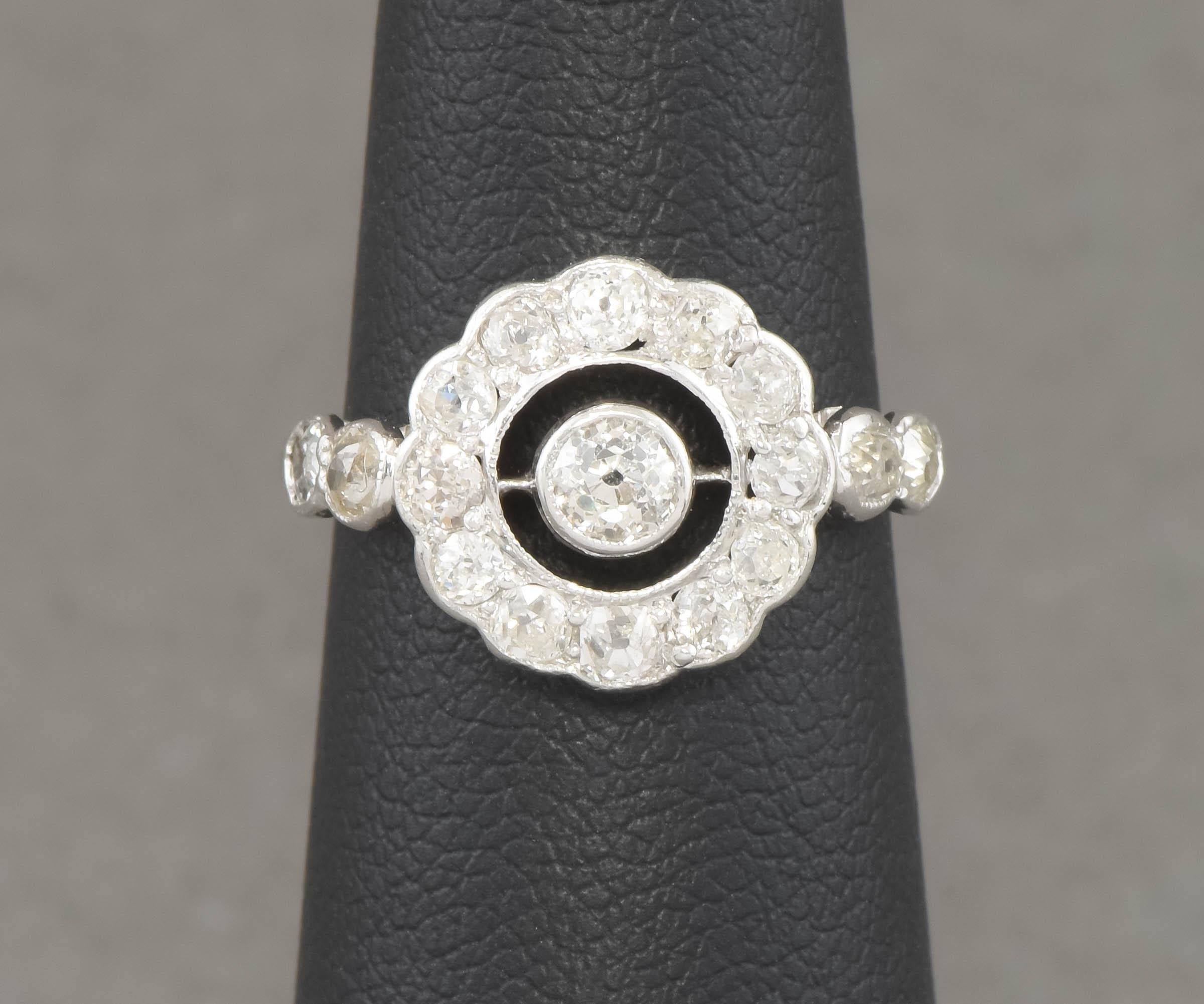 Offered is a charming and very fiery 1930's Art Deco diamond engagement ring with a wonderful Target, Halo, flower or 