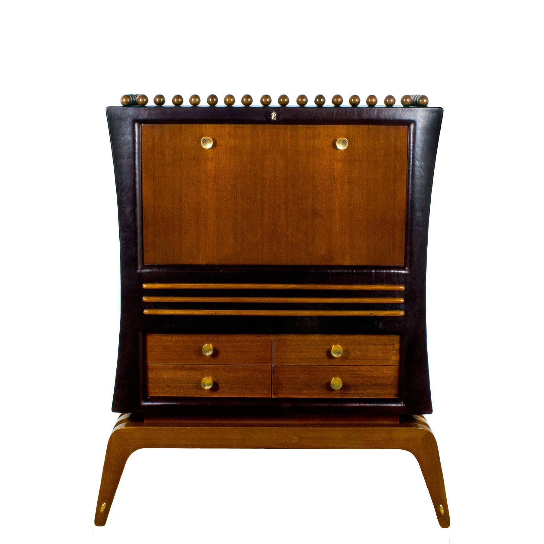 Uncommon Art Deco dry bar, solid wood thick chocolate leather upholstery. Base, drawers and flap door with African mahogany veneer, solid African mahogany balls and strips, French polish. Polished brass handles and decorative hardware. Spectacular