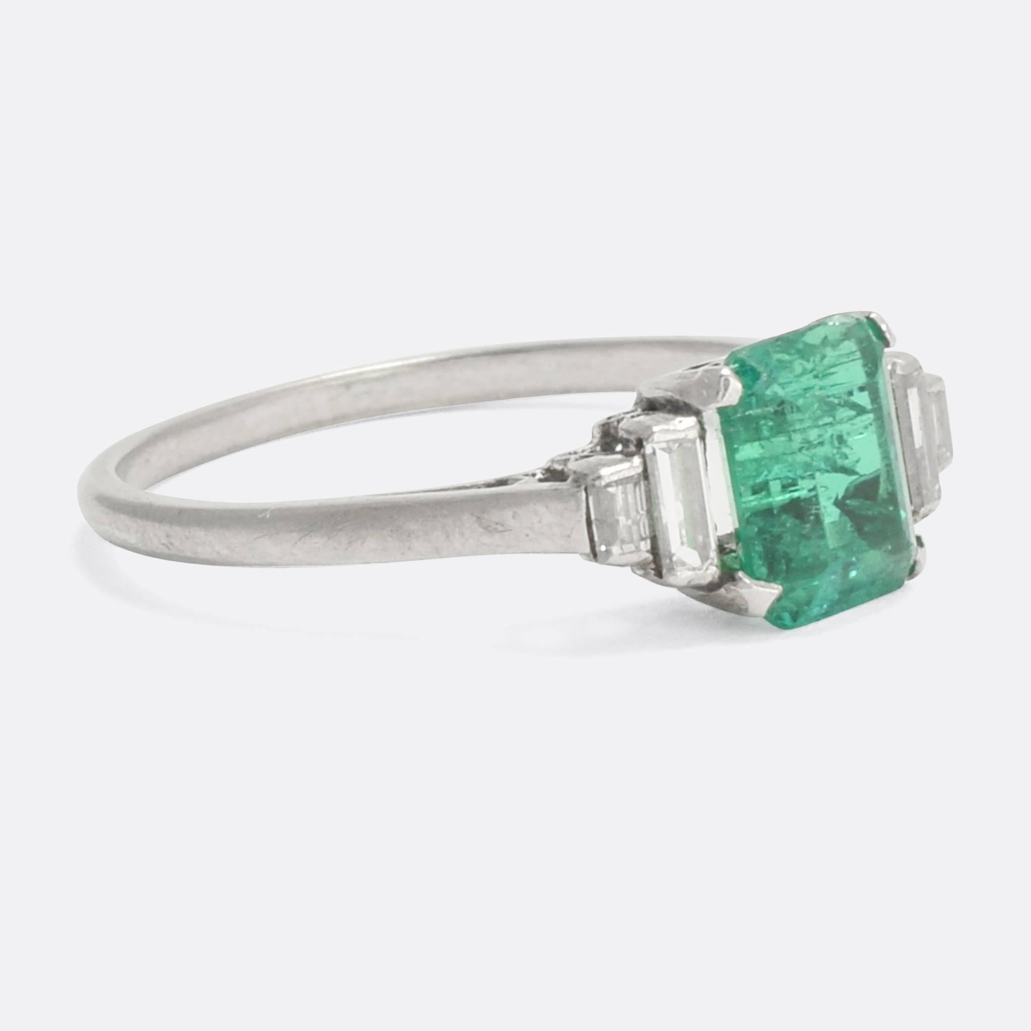 A stunning Art Deco era Emerald and baguette Diamond ring modelled in platinum throughout. It's impeccably styled - dating from c.1930 - and features fine openwork to the gallery, allowing plenty of light in behind the stones. The natural emerald is