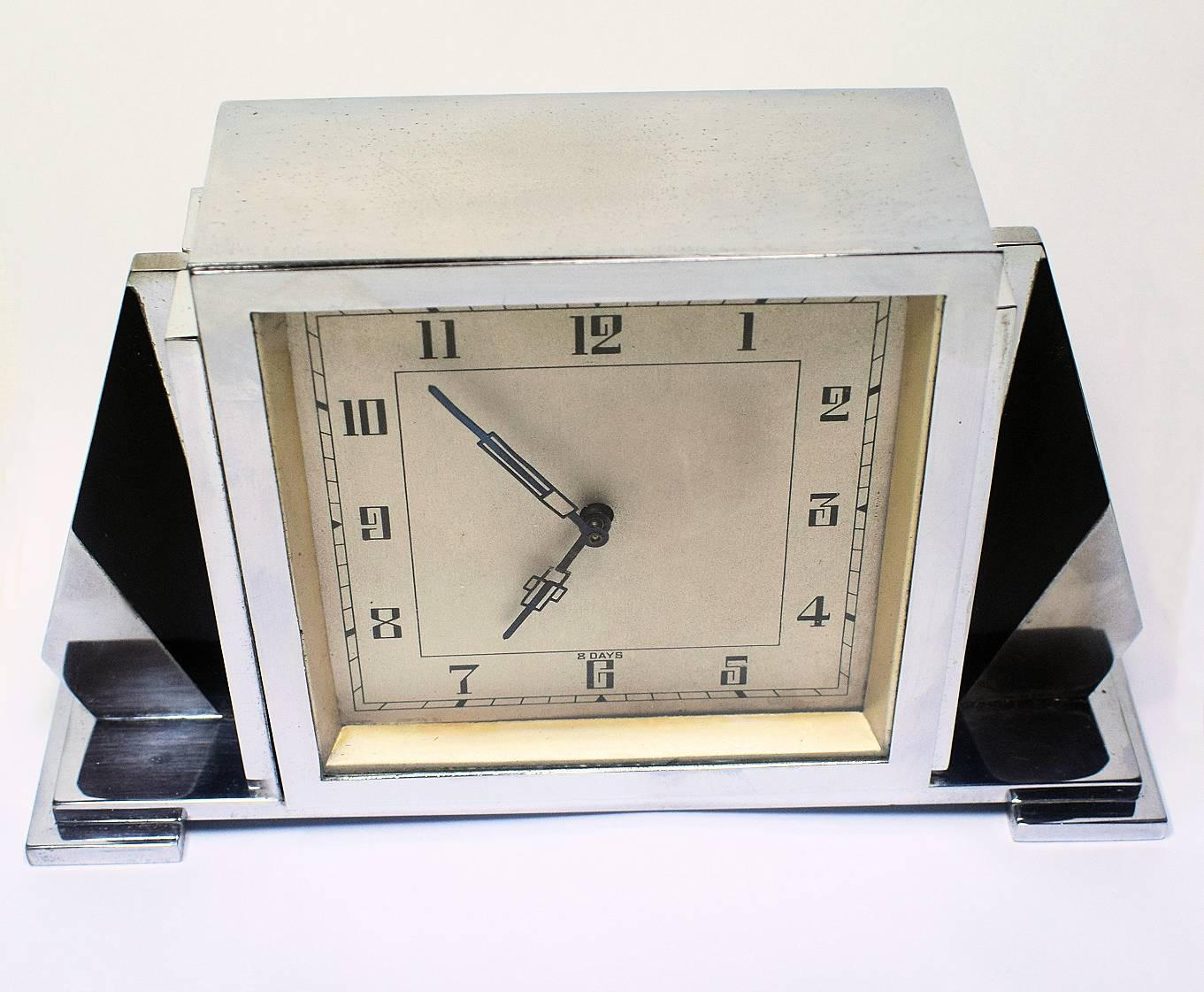 For your consideration is this rather stylish English Art Deco chrome clock with an 8 day movement. Deceptively heavy and of a good quality build. On the back of the clock reads 'British Made'. The black and chrome side fins make this a very
