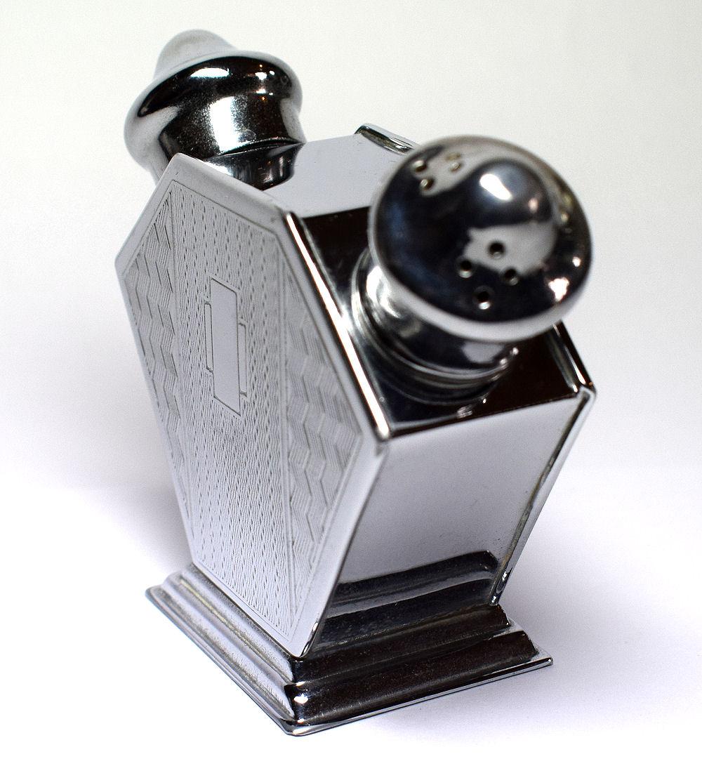 For your consideration is this stylish Art Deco 1930s cruet. Comprising a holder with salt and pepper shakers either side. Both sides of the body are engine turned with a stylized Art Deco decoration. The chrome is highly polished with no dents or
