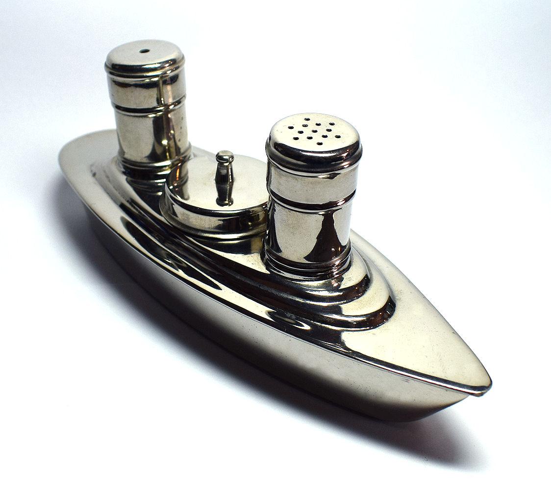 Delightful Art Deco 1930s four part cruet set in the style of a cruise ship liner. Comprising a holder in the shape of a ship, salt and pepper shakers and a lidded mustard pot. The mustard pot has a removable lid and is shaped in a fatter more squat
