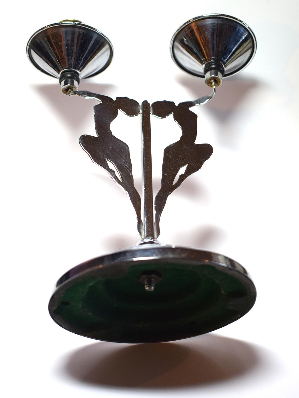 Rare and highly collectable 1930s chrome Art Deco double candlestick featuring nude dancing girls motif. Condition is great with minor clues to its real age. Bakelite accent to the candle holders and a weighted stepped chrome base. Though a very