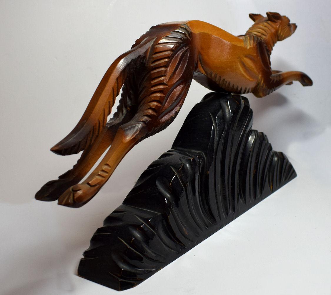 Wonderfully stylish 1930s Art Deco figure depicting a leaping dog, very iconic image from the 1930s. Originating from France and made by the artist P. BELYS, the figure is made from highly lacquered chiselled wood. The detailing is great and