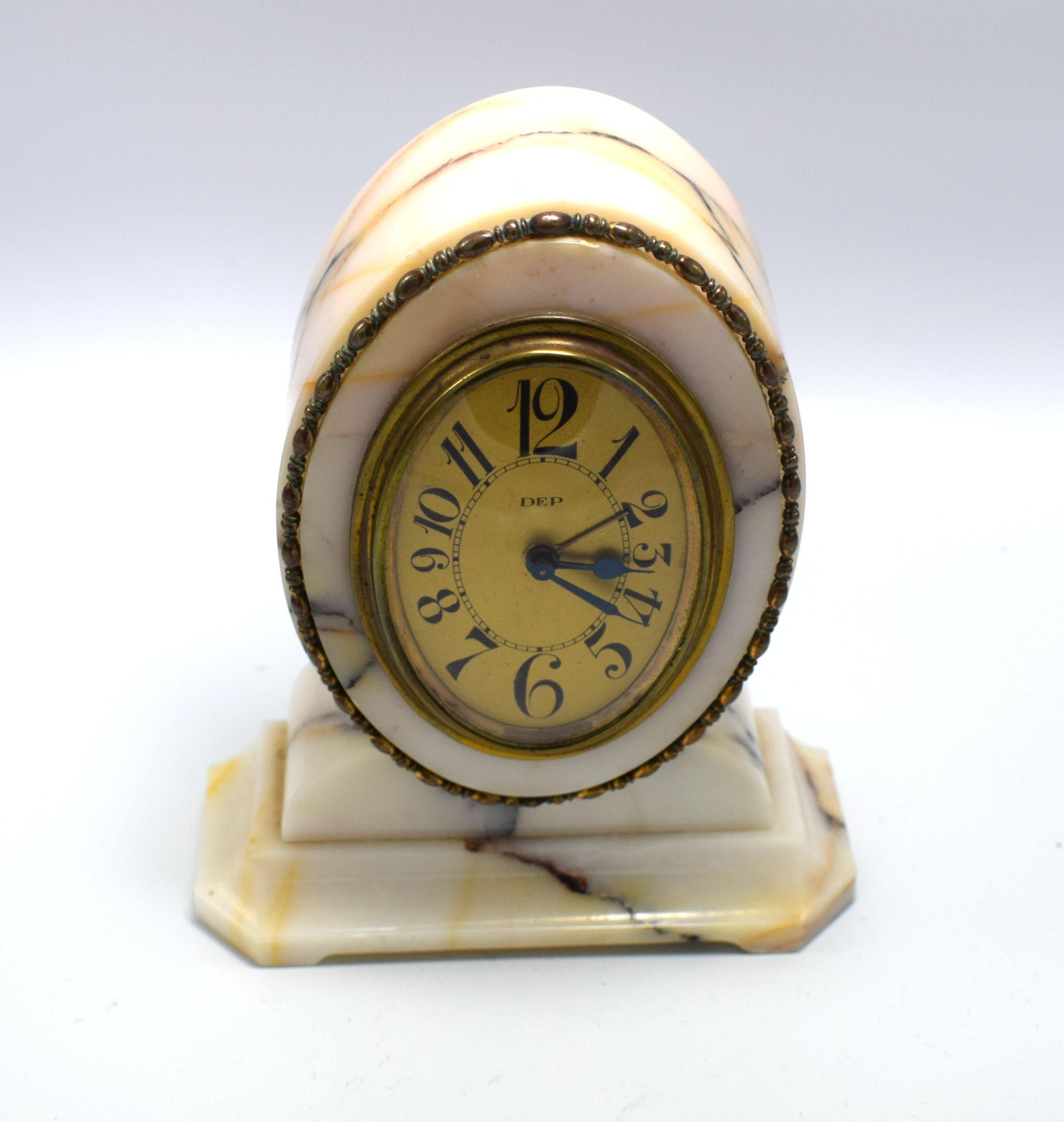 Fabulous 1930s Art Deco French alarm bedside clock by Dep. Really cute size, please see dimensions. The clock is encased in a cream /off white marble with beautiful pink and black veins running through. Unusual oval shape with brass accents. Great