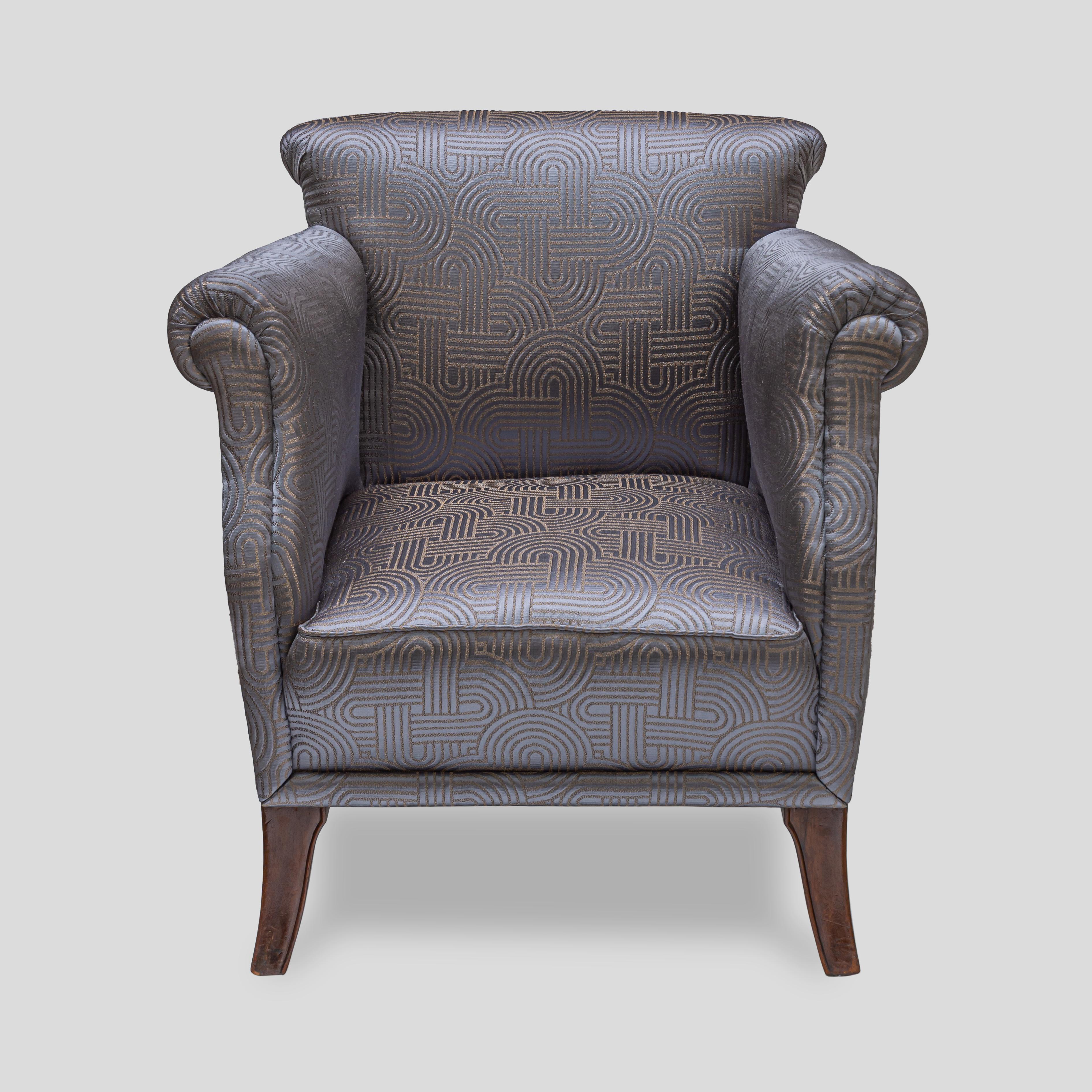 1930s Art Deco armchair, The chair has been completely re-upholstered in a comfortable and cosy light grey blue patterned satin fabric on chocolate brown wooden legs. The frame is in good condition, all the joints and backrest are original and