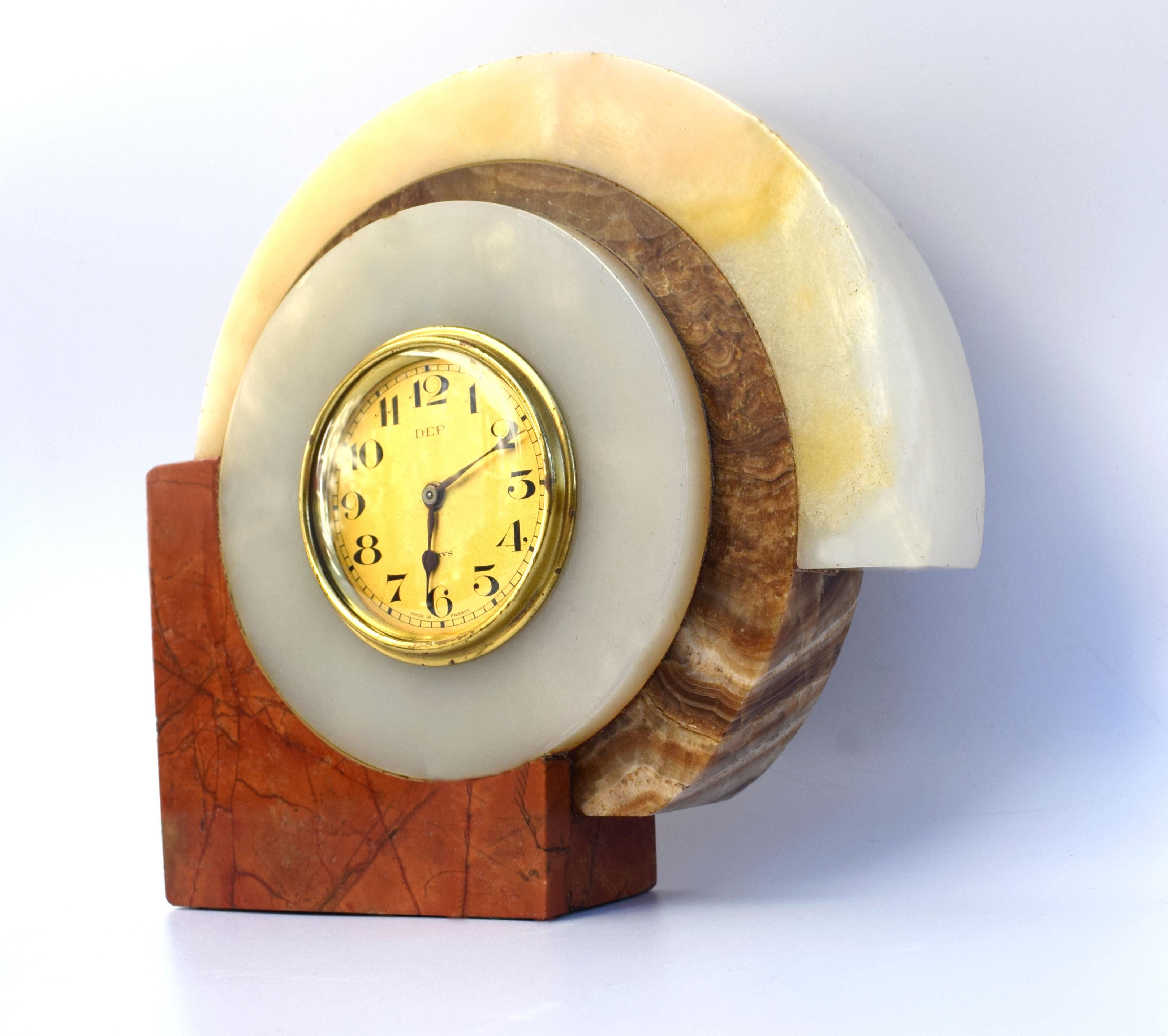Very striking 1930s Art Deco French clock by Dep. The case is solid multicolored marble, the bezel and face are in gold tone metal. Very iconic Art Deco marble casing. This clock is a really good size and ideal as a desk clock or side table. All of