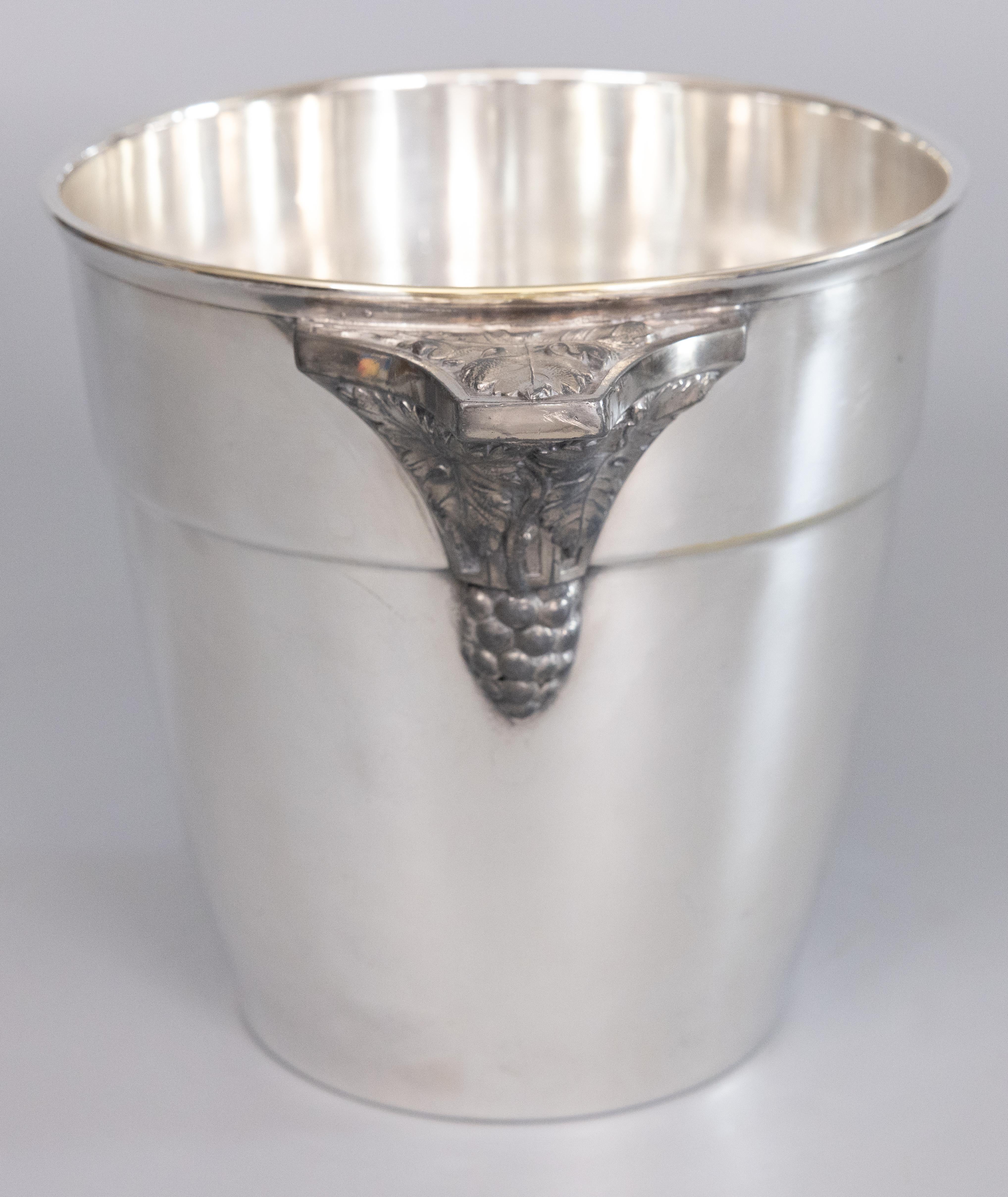 A fabulous early 20th-Century silverplated champagne bucket or wine cooler, made in Paris, France, circa 1930. Signed on reverse. This fine quality ice bucket is solid and heavy with grapes and leaves pewter handles and a sleek design, perfect for