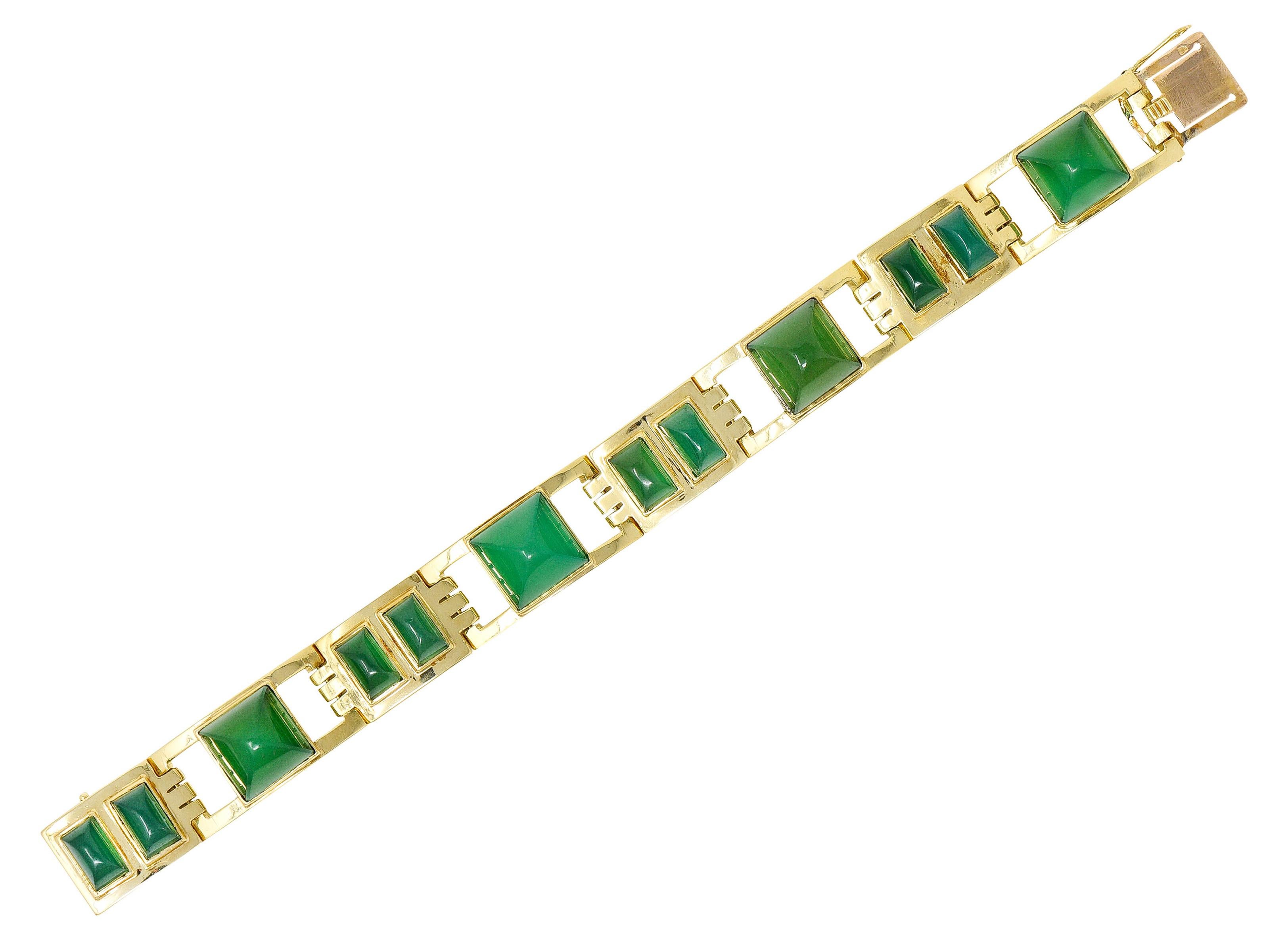 Link bracelet is comprised of arched panels pierced in a geometric design

Featuring large sugarloaf cabochons of chrysoprase alternating with sets of rectangular chrysoprase sugarloaf cabochons

Translucent with vibrant and uniform bluish green to