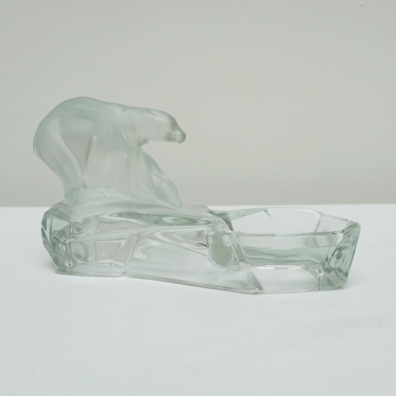 An Art Deco glass ashtray designed by Karel Zentner for by Feigl and Morawetz Libochovice glassworks, depicting a polar bear and cub standing on an ice floe. Frosted and clear glass. Stamped to underside. 
Dimensions: H 13cm W 23cm D 10cm