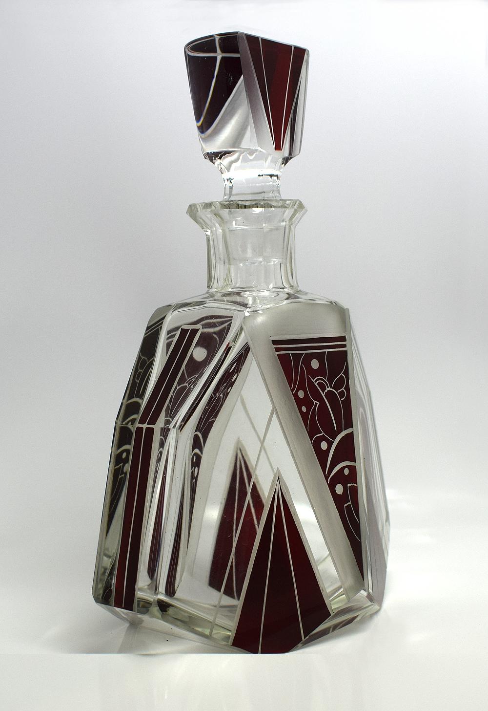 Fabulous 1930s Art Deco decanter set. Comprises a deceptively heavy cut-glass decanter, stopper and six good sized glasses, all with enamel and etched geometric decoration. The wonderful set oozes quality. All in great condition, free from nibbles