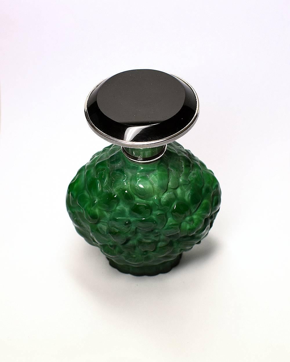 Beautiful 1930s Art Deco green malachite glass perfume bottle with solid silver and black glass lid. Made in Czechoslovakia. This wonderful piece comes to you in excellent condition with no flaws to mention.