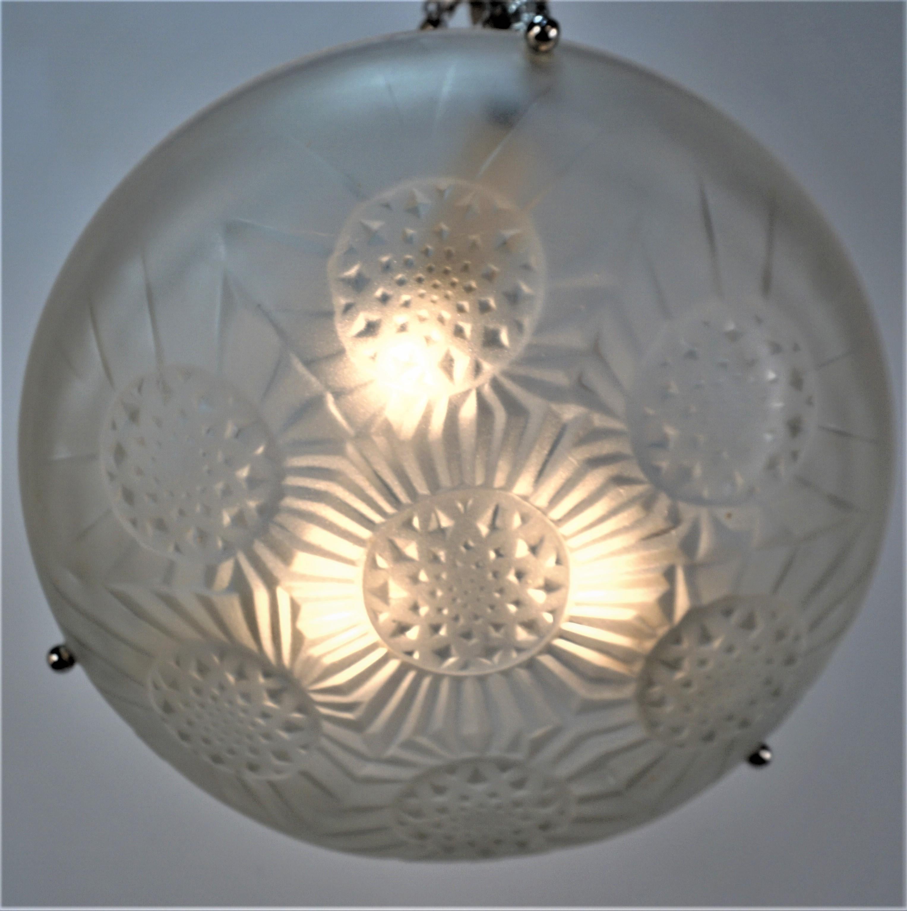 A beautiful three light Art Deco fixture. Made in France by the noted glassmaker Jean Noverdy, this chandelier is signed 