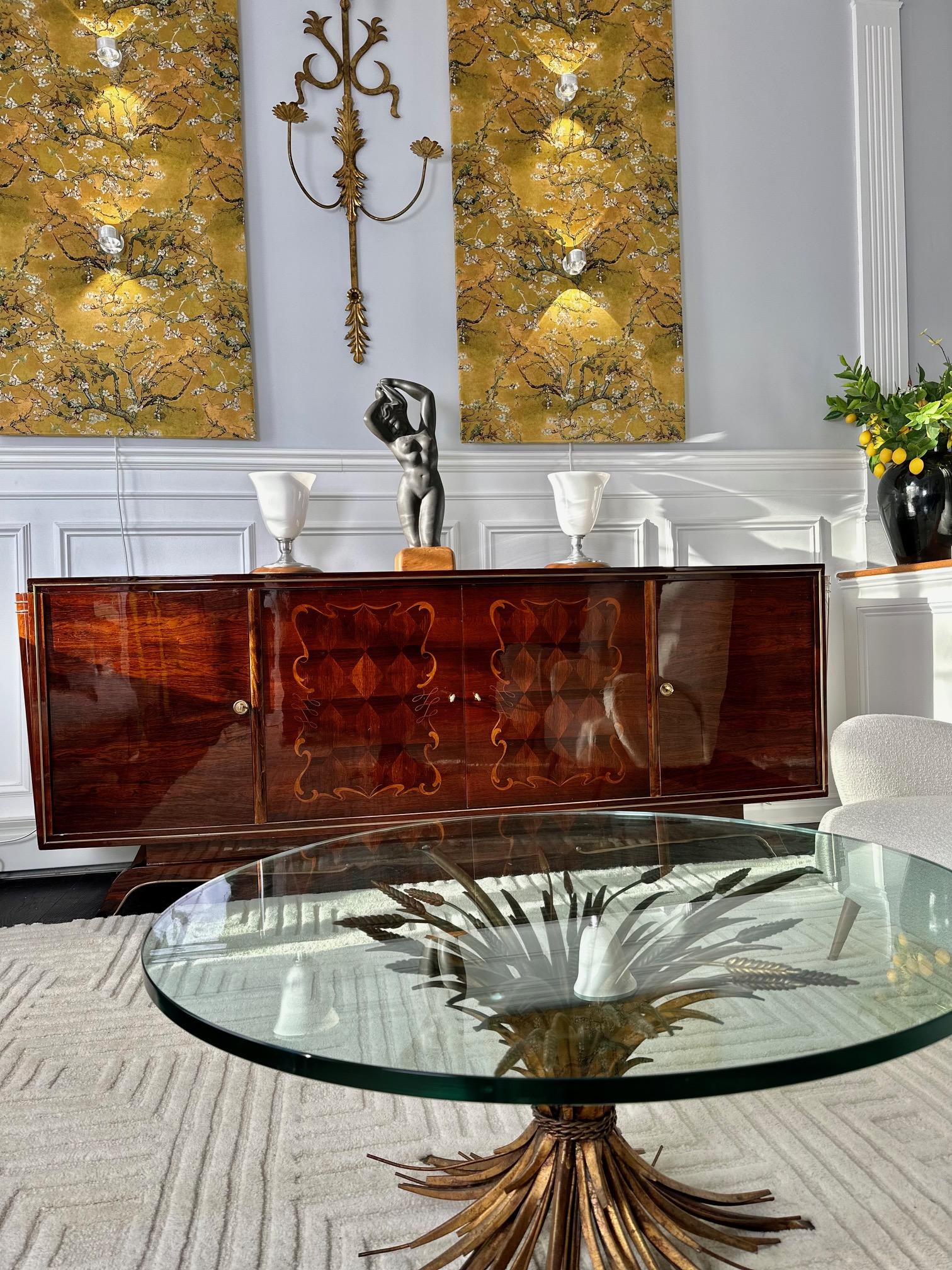 This is a beautiful Art Deco sideboard or credenza made from solid oak and Macassar ebony veneer. The buffet's drawers, inside doors and shelves is made of Sycamore wood. It features elegant bronze elements attributed to Jules Leleu, renowned French