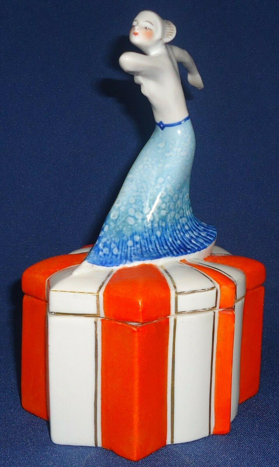 Wonderful 1930s Art Deco ceramic powder box with female dancer depicted on the lid. Beautiful colouring and detailing. A rare design and highly sought after. She's in great condition with no damage or restoration. Moulded on the base are 1734