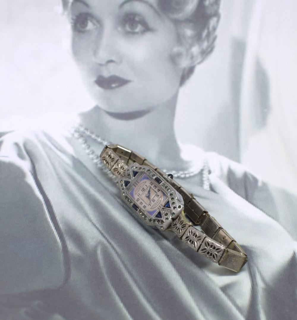 Wonderfully stylish Art Deco ladies sapphire marcasite enamel watch with a filigree Band. Originating from the 1930's and made by Luber. It feels very comfortable worn and is able to be slackened and tightened for varying wrist sizes. Original white