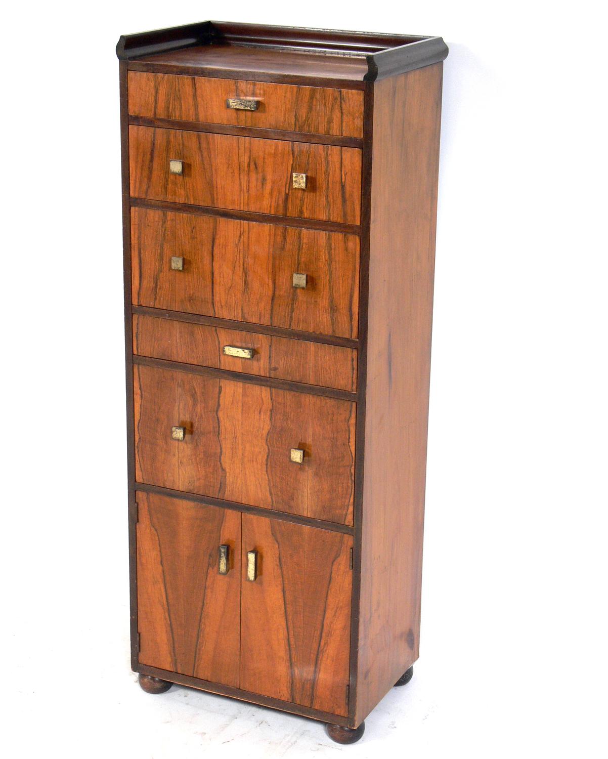 Art Deco lingerie chest or Semanier, designed by David Robertson Smith for Dynamique Creations, American, circa late 1920s-early 1930s. Constructed of beautifully grained rosewood, olive wood, and mahogany with brass hardware. It offers a voluminous