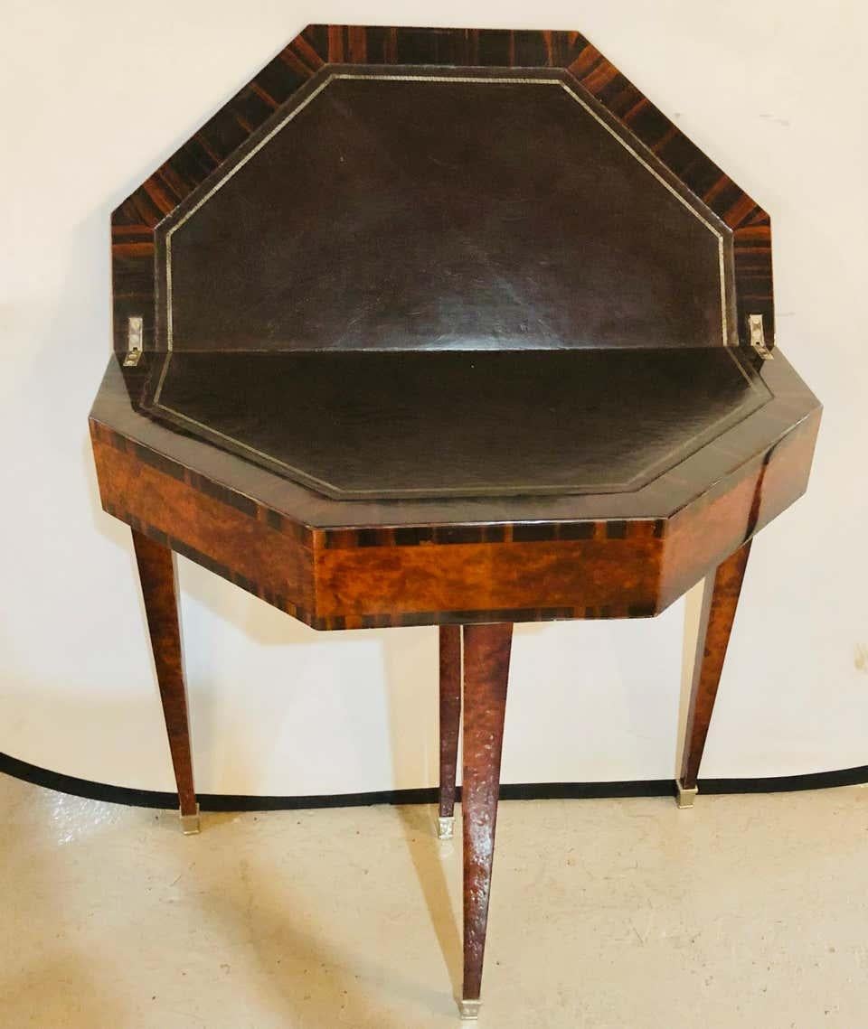 1930s Art Deco Macassar card serving table. Octagon end table when opened measures 31.25 inches in diameter and 15.50 inches when closed.