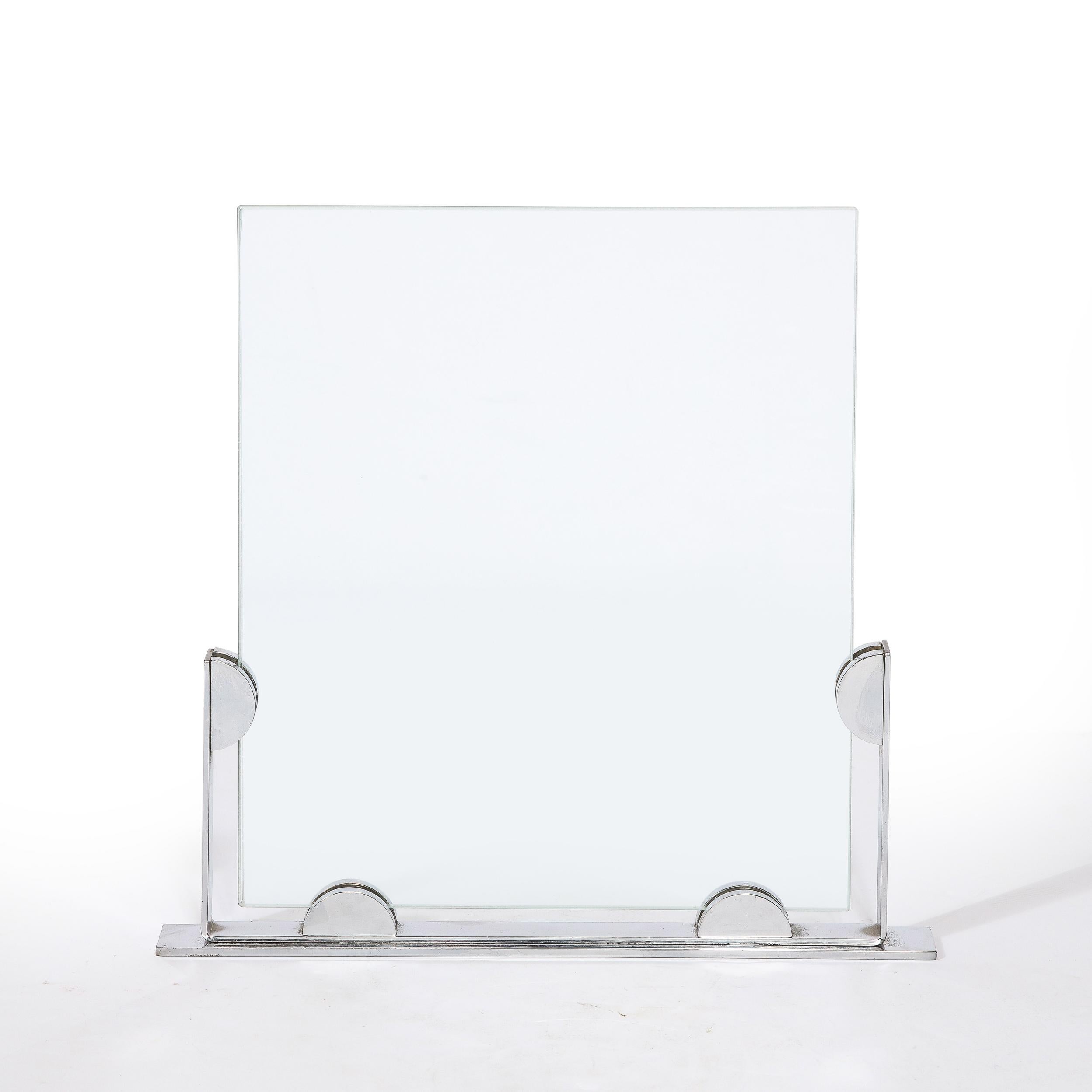 This elegant Art Deco Machine Age picture frame was realized in the United States, circa 1935. It features an austere frame consisting of an open form rectangle in lustrous chrome with a pair of streamlined supports at the base, as well as another