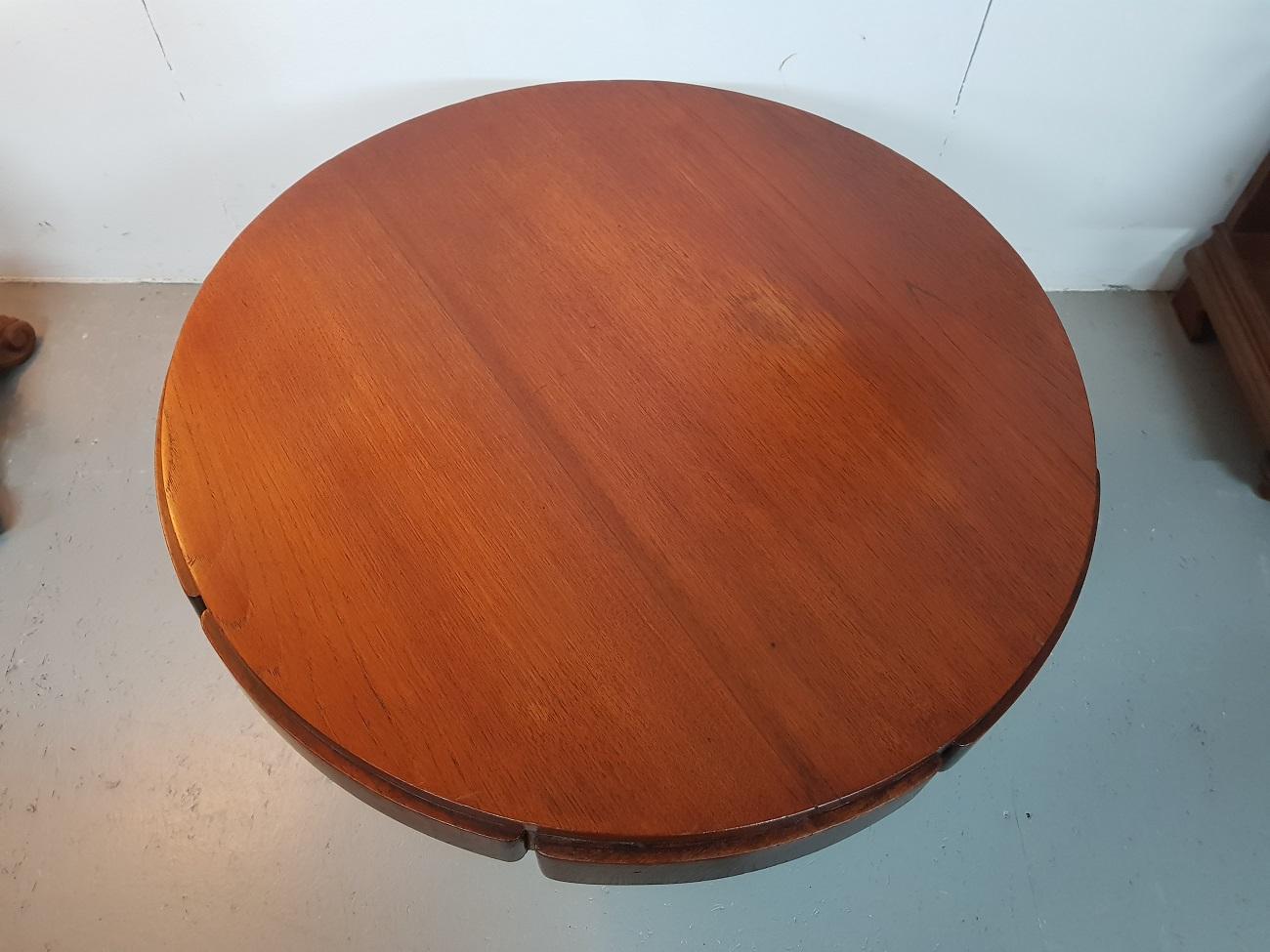 Beautiful designed Art Deco mahogany coffee table standing on a cross base with additional shelves and branded Deerns, made in the 1st half of 20th century. It has a small spot on the surface and wear consistent age and use.

The measurements
