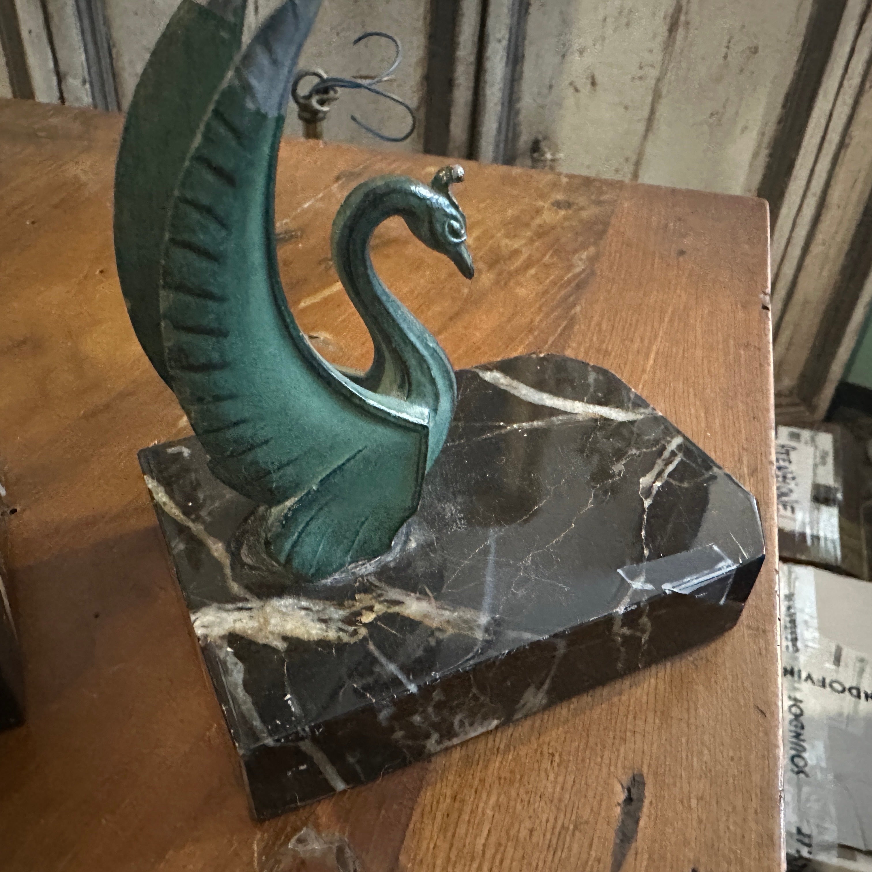 This is a pair of 1930s Art Deco French bookends. Each bookend features a sculptural swan design made of metal, which exudes an elegant and streamlined aesthetic typical of the Art Deco period. The swans are mounted on substantial marble bases,