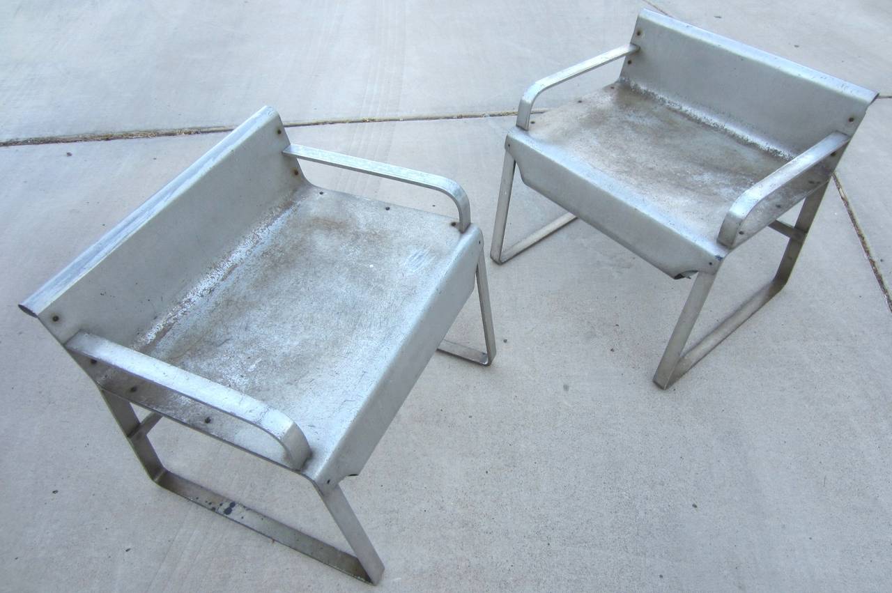 Rare pair of low aluminum arm stools or chairs by 