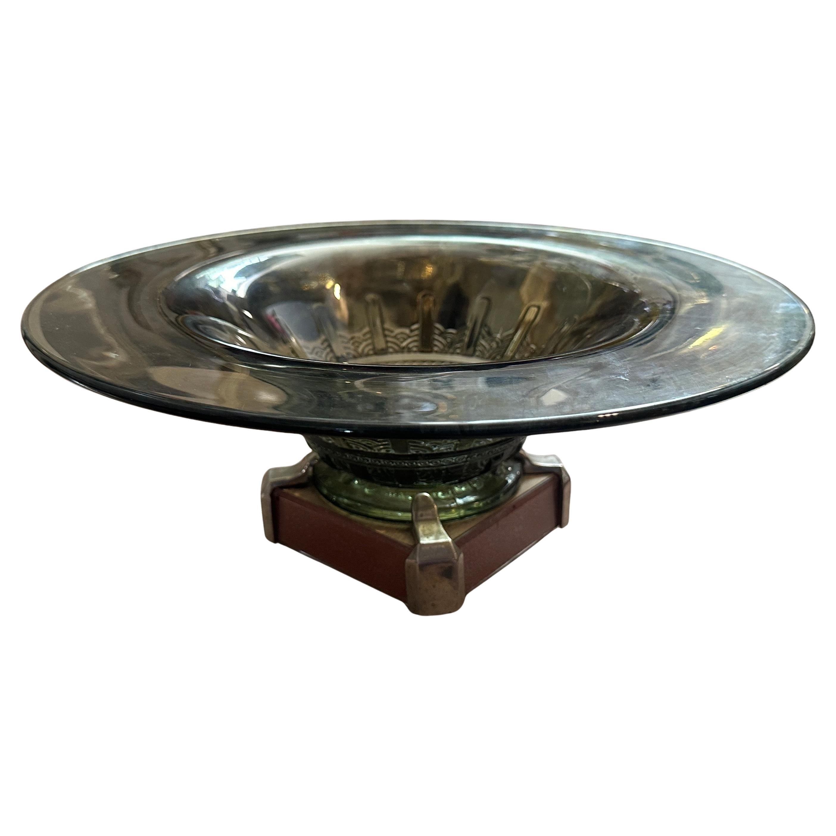 This 1930s Art Deco French centerpiece made of metal and green glass has a wide, shallow metal bowl with a reflective finish, featuring a slightly flared rim. The bowl's interior has an elegant, embossed pattern that enhances its visual appeal. It