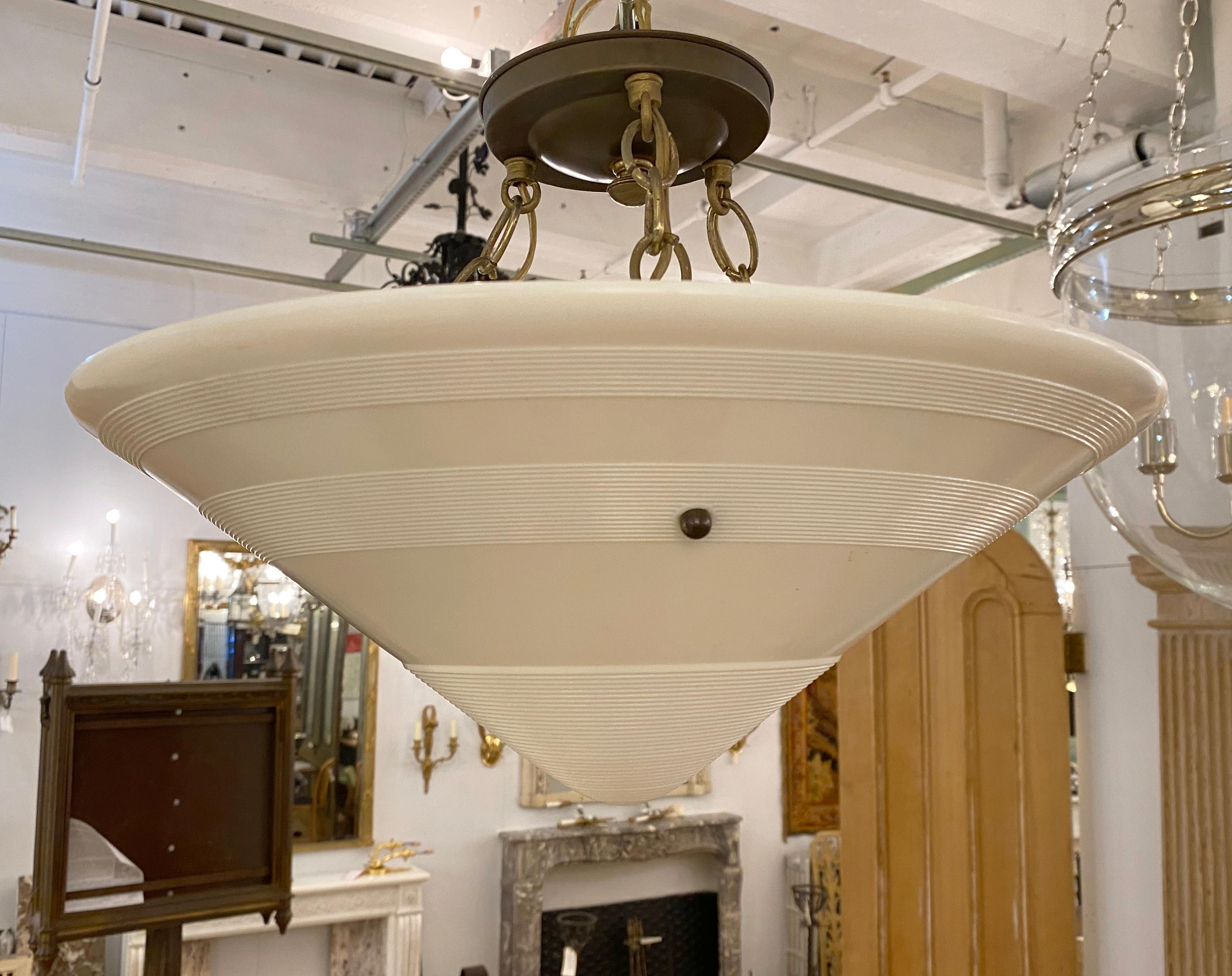 1930s Art Deco heavy cast milk glass dish light with bands concentric grooves. Canopy has three chain attached to the dish shade. Features three medium base household sockets. Small quantity available at time of posting. Priced each. This can be