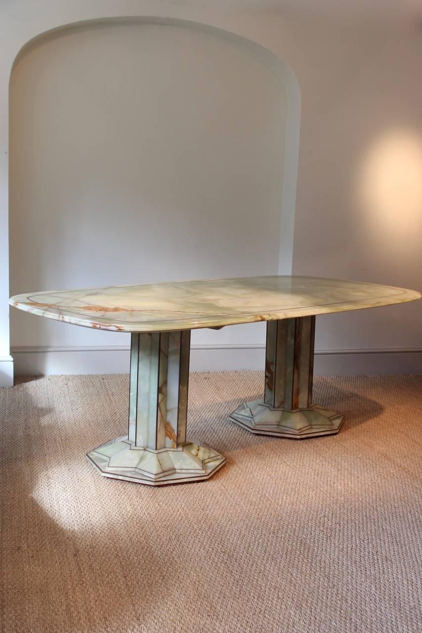 A very striking and of great design, circa 1930s French Art Deco dining table in onyx with copper inlay that will comfortably seat eight people.
 