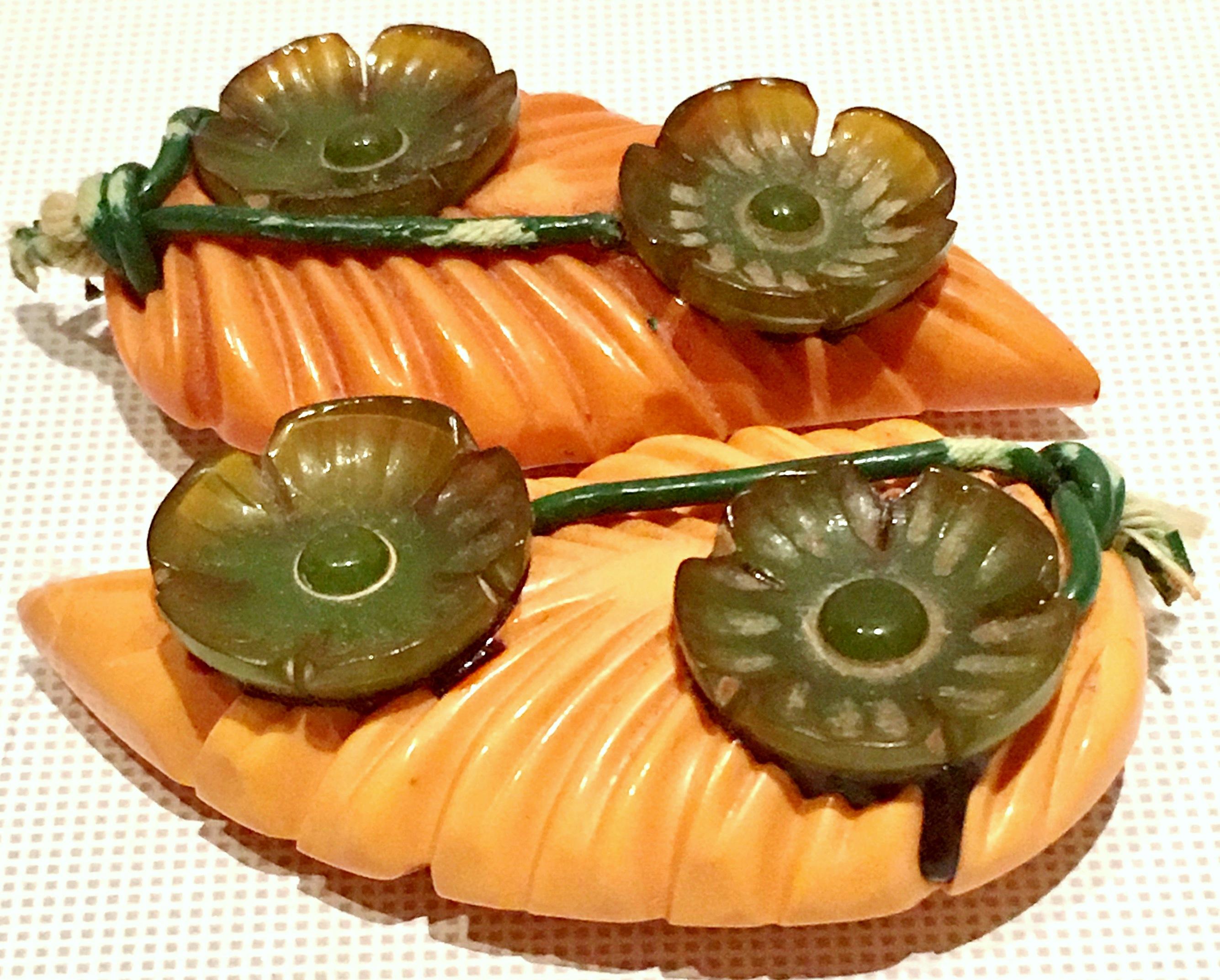 1930'S Pair Of Rare & Unique Bakelite Deeply Carved Dress Or Fur Clips. These studio art clips feature,  a combination of Bakelite butterscotch and green, deeply and intricately carved dimensional abstract leaf form motif. Can be used in a number of