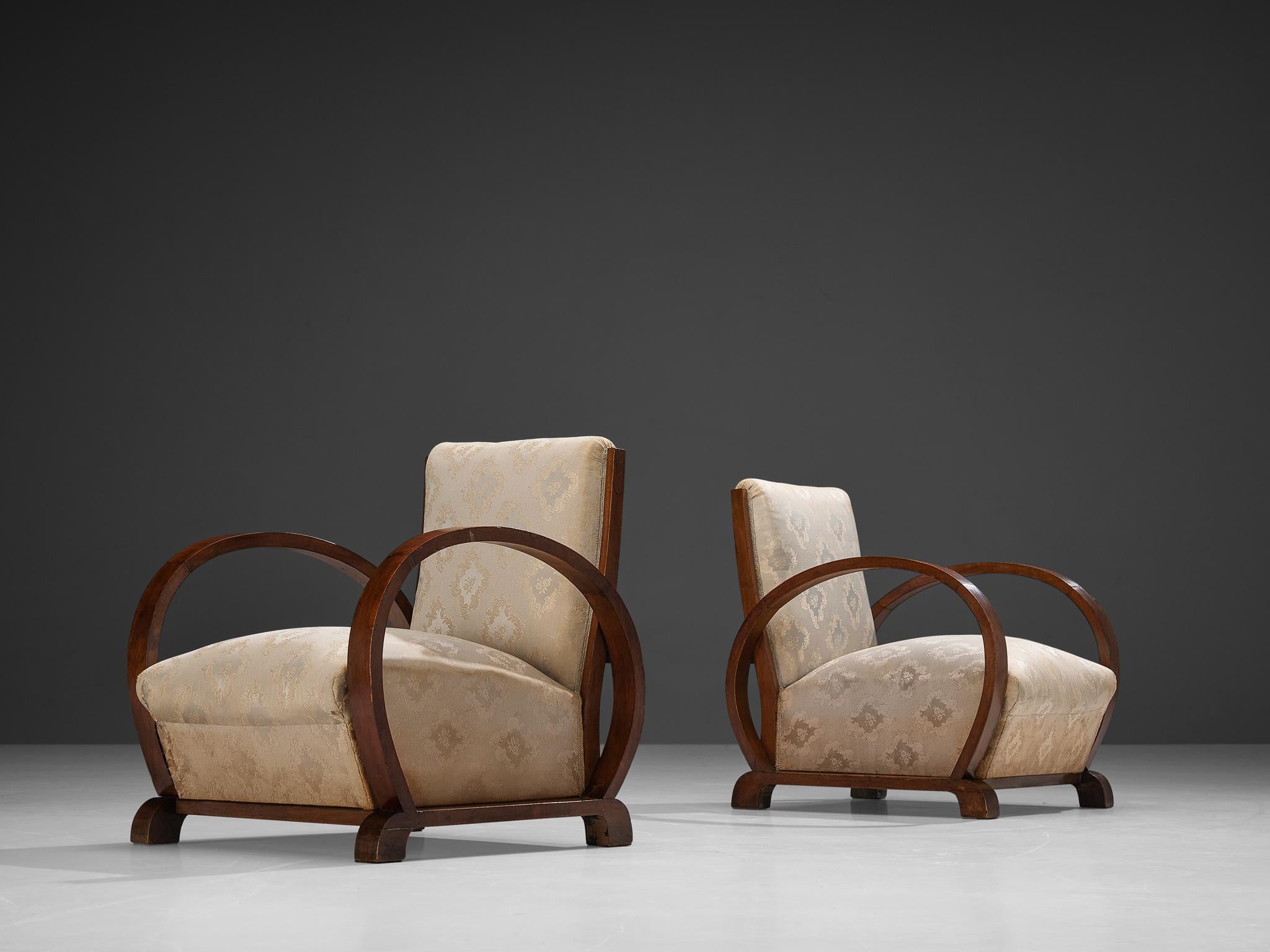 Pair of lounge chairs, walnut, fabric, Italy, 1930s

These beautifully designed armchairs are created in one of the most influential periods for the arts namely the Art Deco Movement. The armrests are curved in a hemispherical shape which is typical