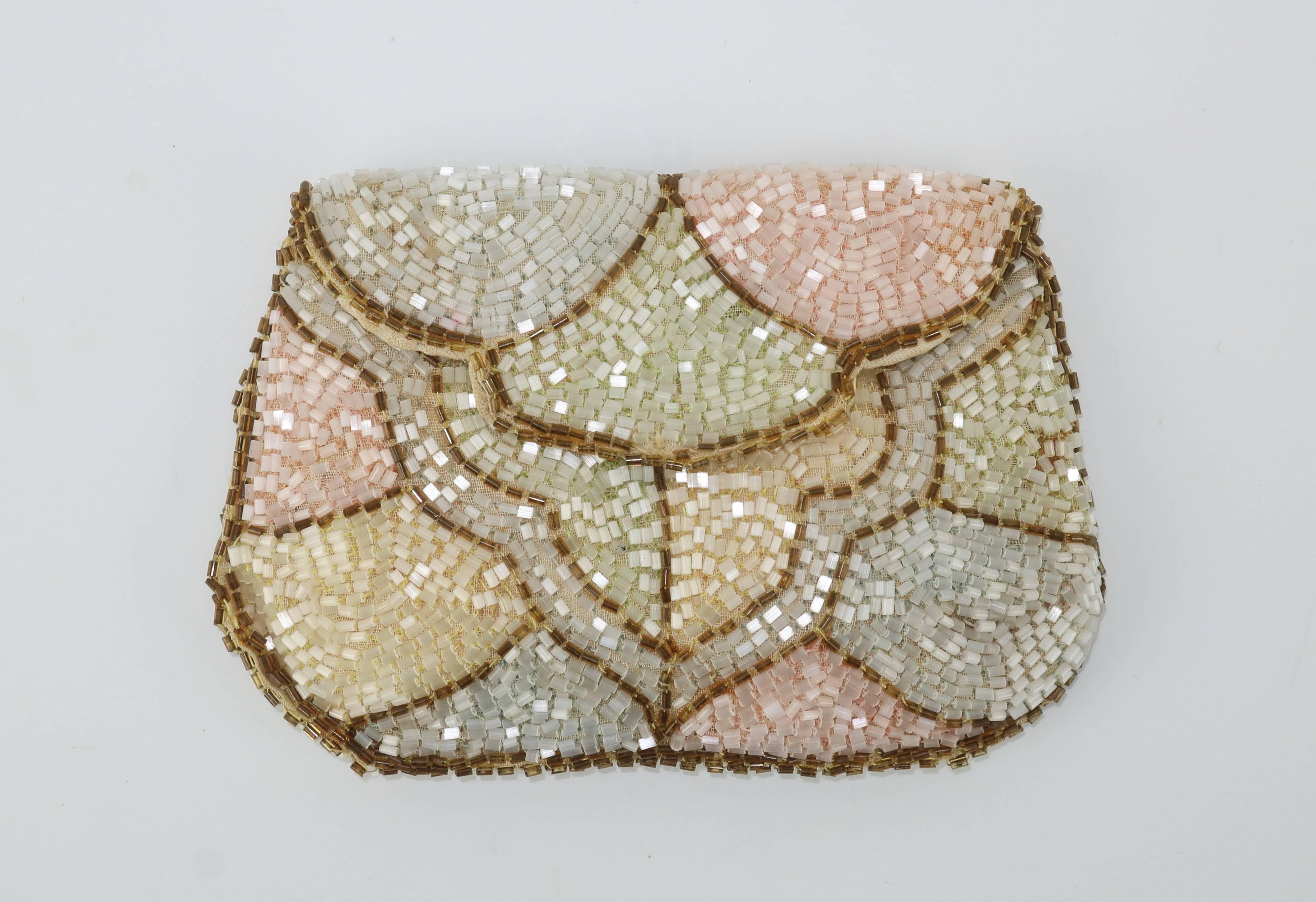 This diminuitive beaded clutch handbag is as sweet as the pastel candy colors it displays so charmingly.  The deco patterned design is actually a fabric in pale shades of green, blue, yellow and pink fully embellished with shimmering beads and