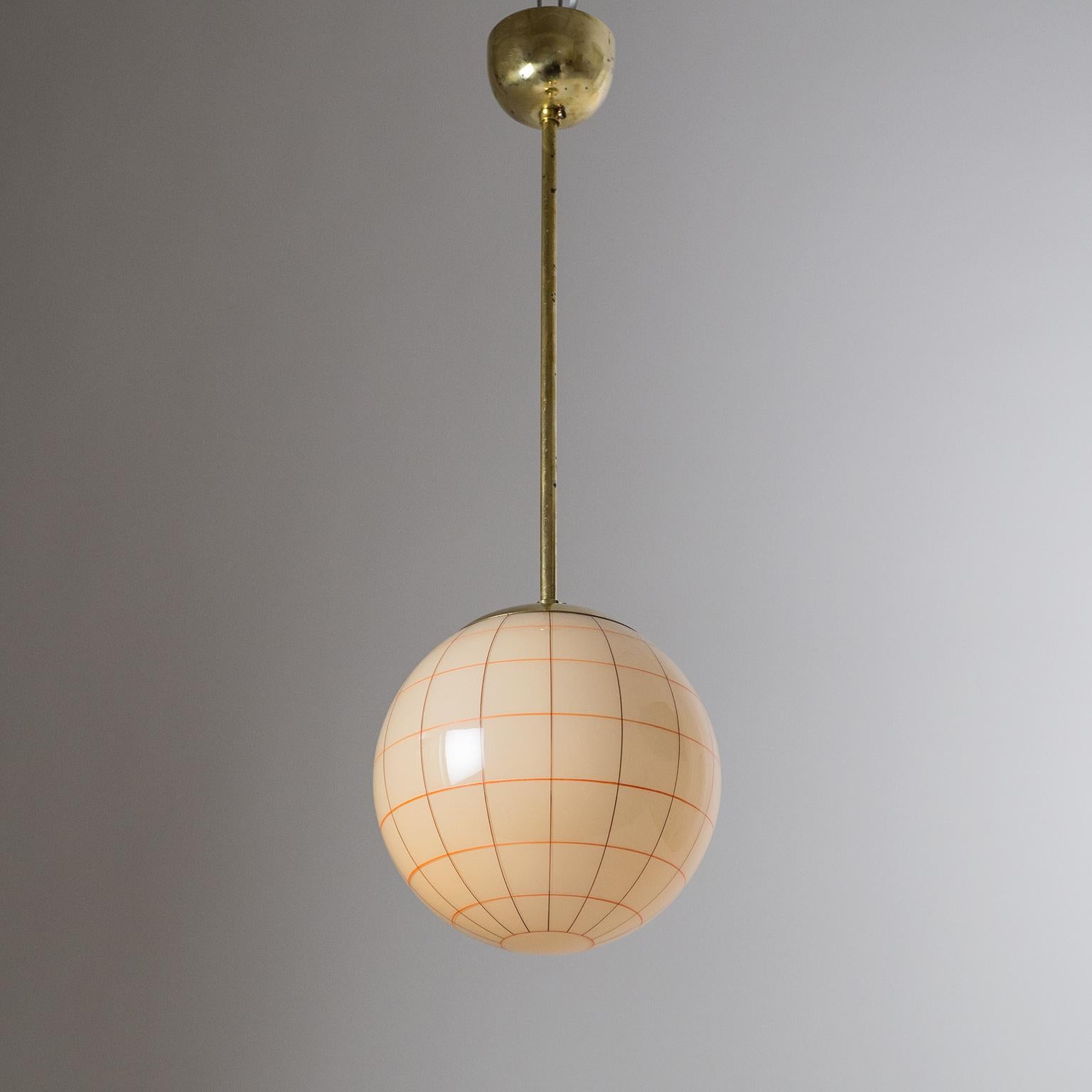 Lovely Art Deco glass pendant from the 1930s. The color of the glass is perhaps best described as 'pastel peach' or perhaps 'caramel cream' and has very fine meridians hand-painted in red and dark brown. The paint and glass are in beautiful original