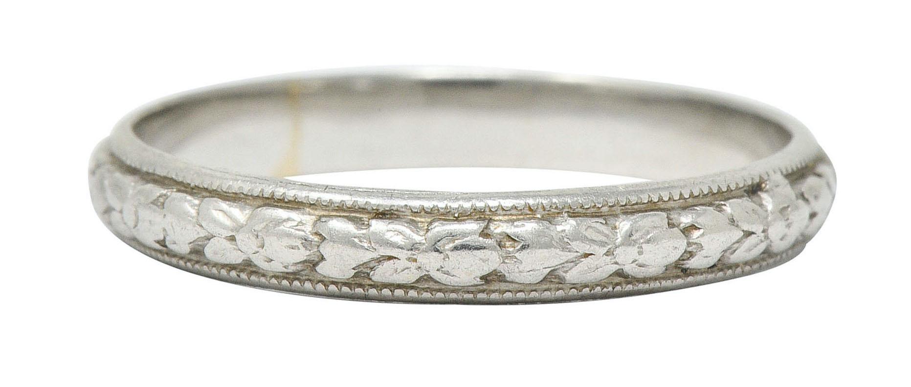 Band ring features a highly rendered motif of orange blossoms and foliate

Flanked by milgrain edges

Stamped Plat for platinum

Circa: 1930s

Ring Size: 6 & not sizable

Measures: 2.8 mm wide and sits 1.3 mm high

Total weight: 2.8