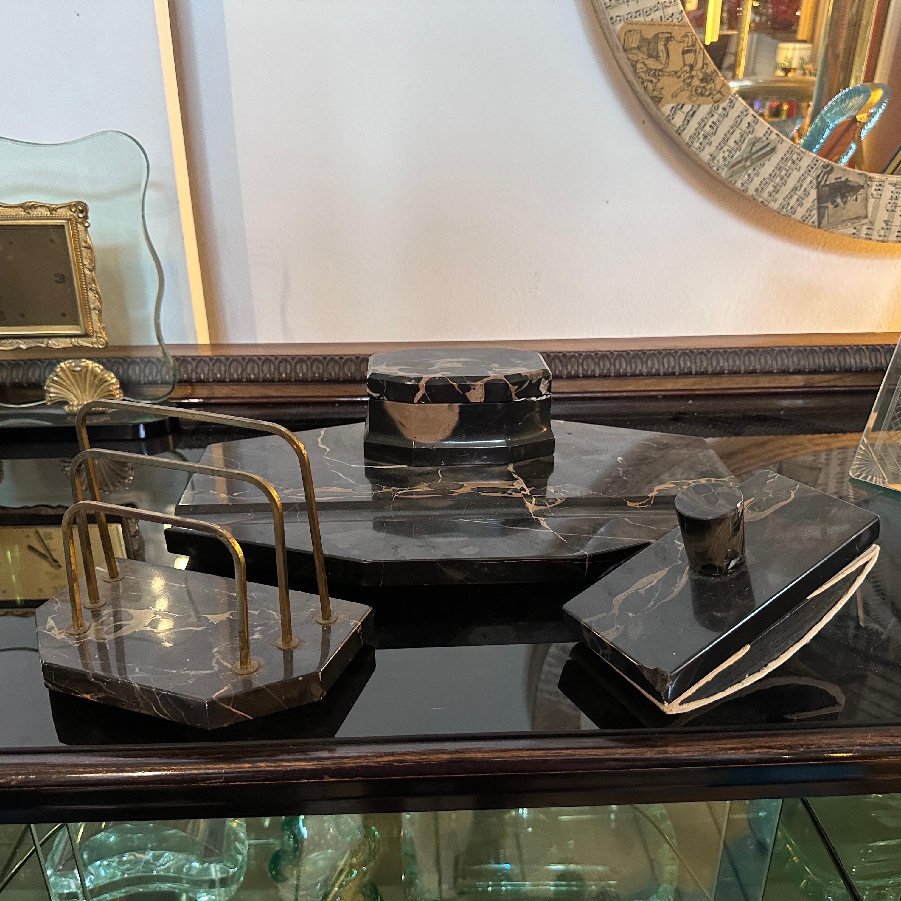 An art deco desk set manufactured in Italy in the Thirties, in original conditions with small signs of use and age, brass it's in original patina. Dimensions are of the Inkstand. This Desk Set is an exquisite embodiment of the opulent and geometric