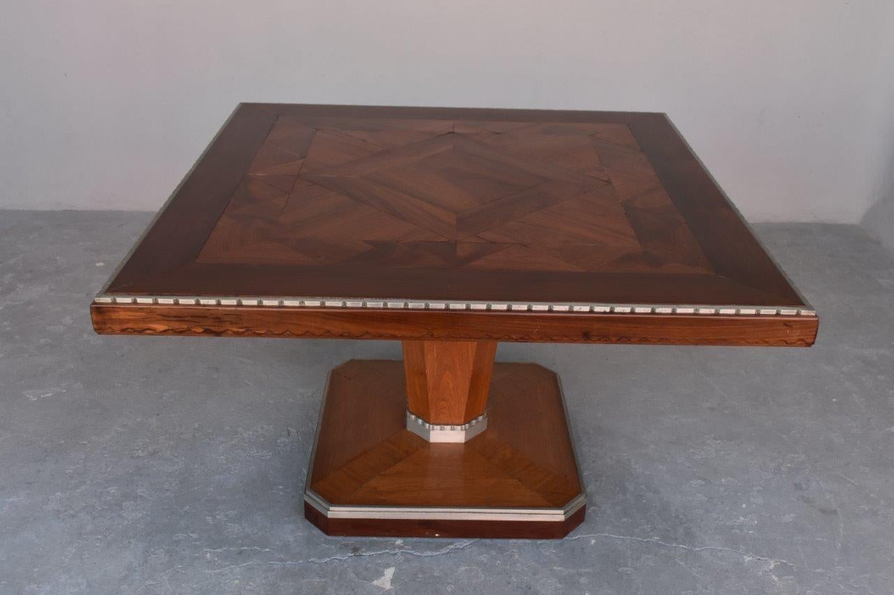 1930s Art Deco rosewood square pedestal table. Decorated with folded cast iron alloy. In the style of Dominique - Paris.