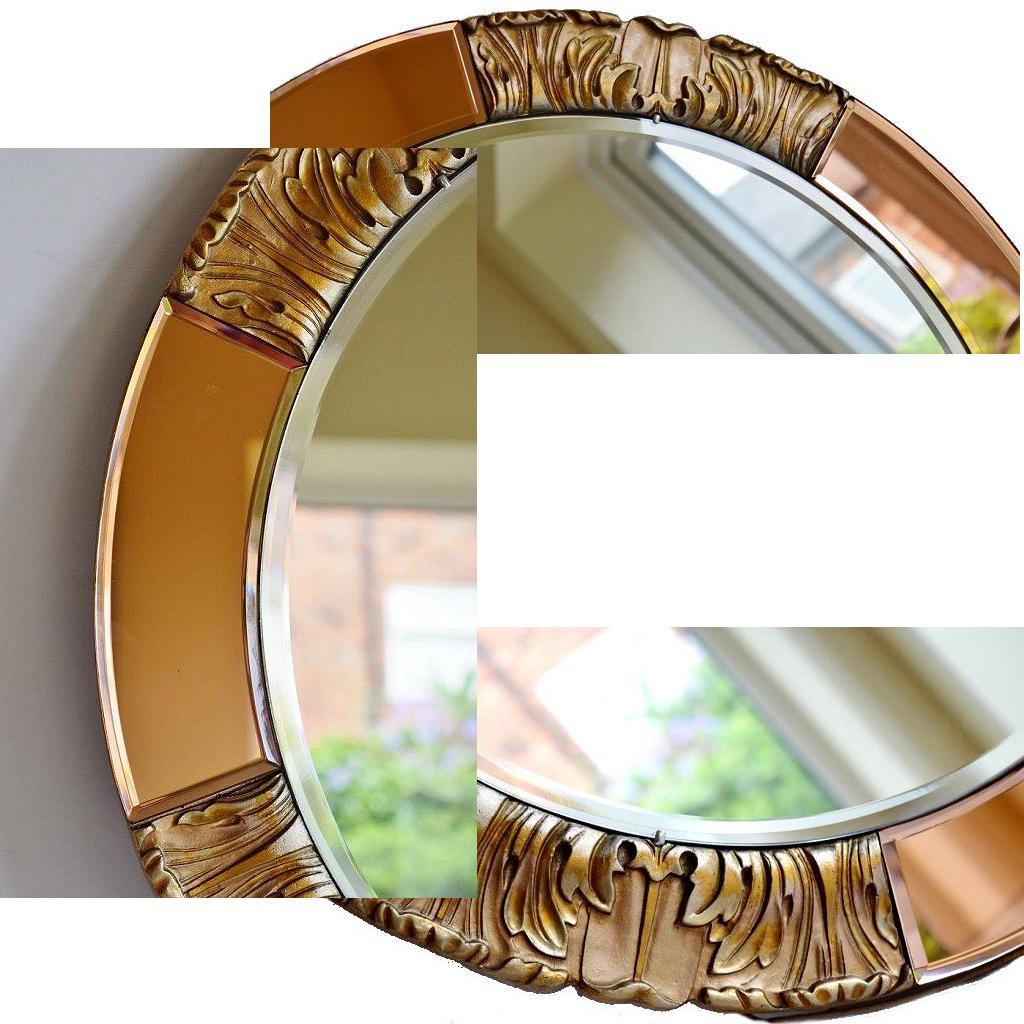 Mounted on the original stippled and gilded wood backing, this lovely Art Deco mirror has the original makers label for 