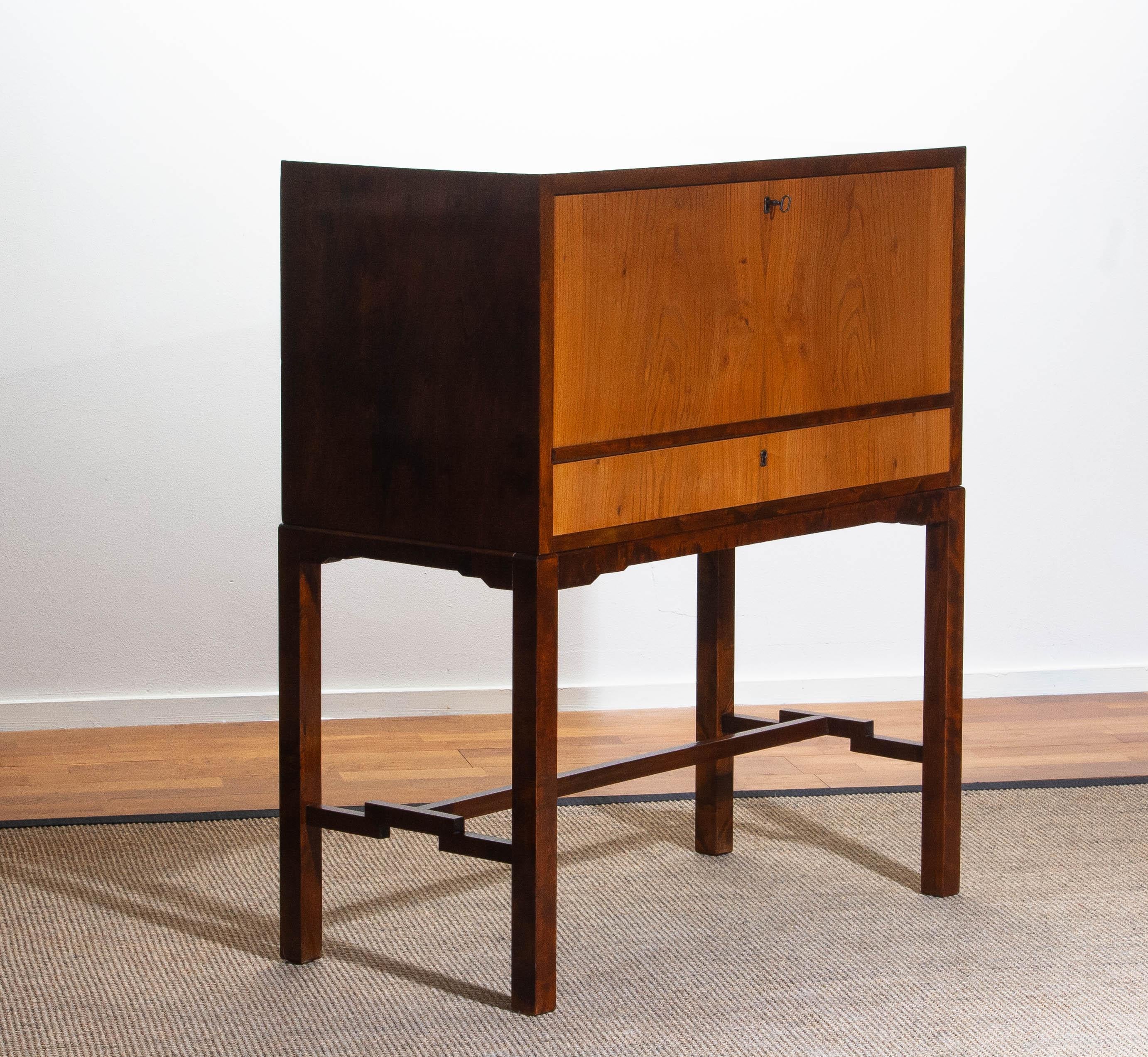 Extremely luxury and high quality secretaire from the 1930s made by Nordiska Kompaniet Stockholm in walnut - elm - birch and mahogany.
Secretaire and front drawer both open / lock with the same key. Secretaire and front drawer are veneered in open
