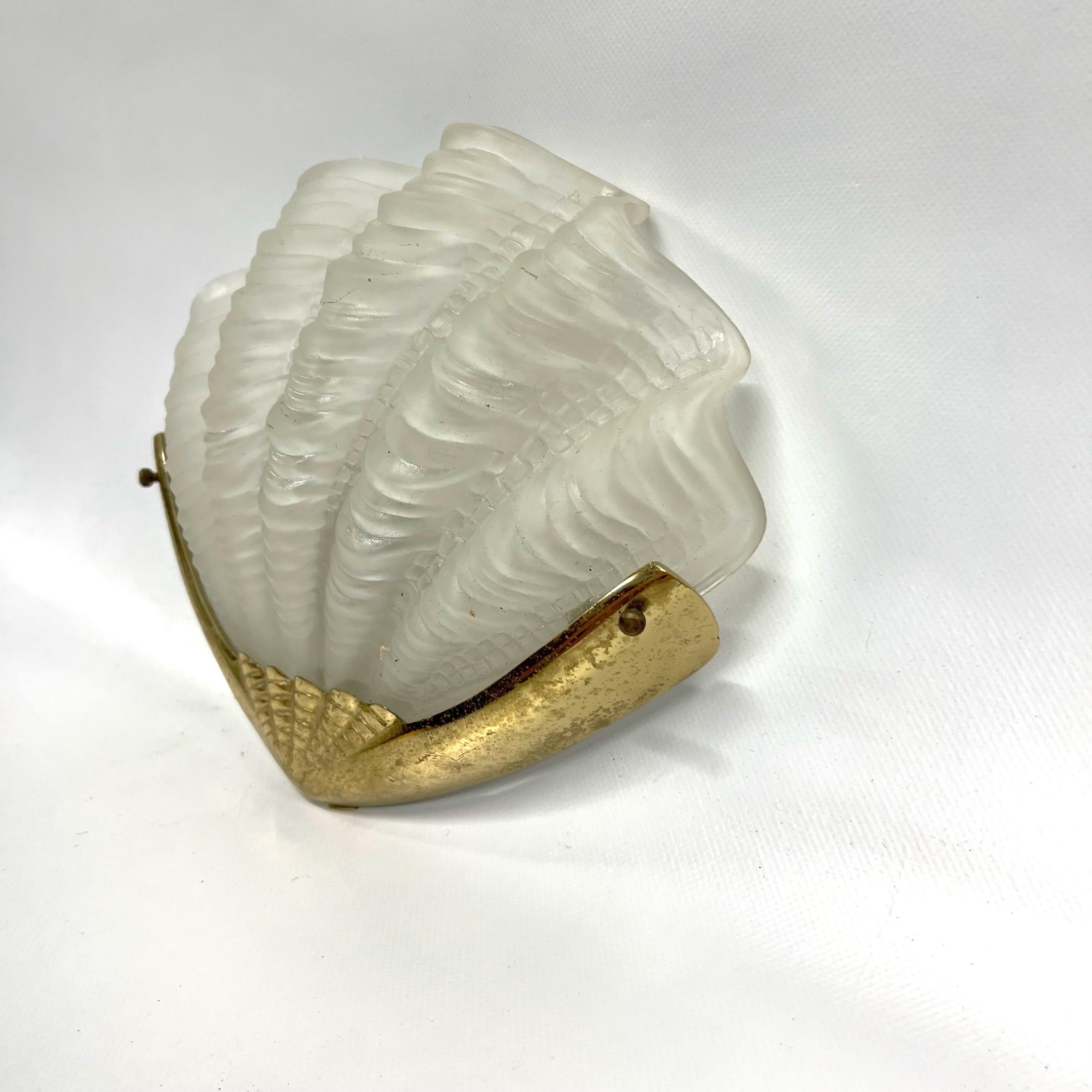 A fabulous opaque Art Deco Shell Wall Lights
 with brass gilt backplate. The opaque shells sit firmly in the backplate, secured by 2 brass fitments. The backplates screw neatly and simply to the wall. The shells are in very good condition with no