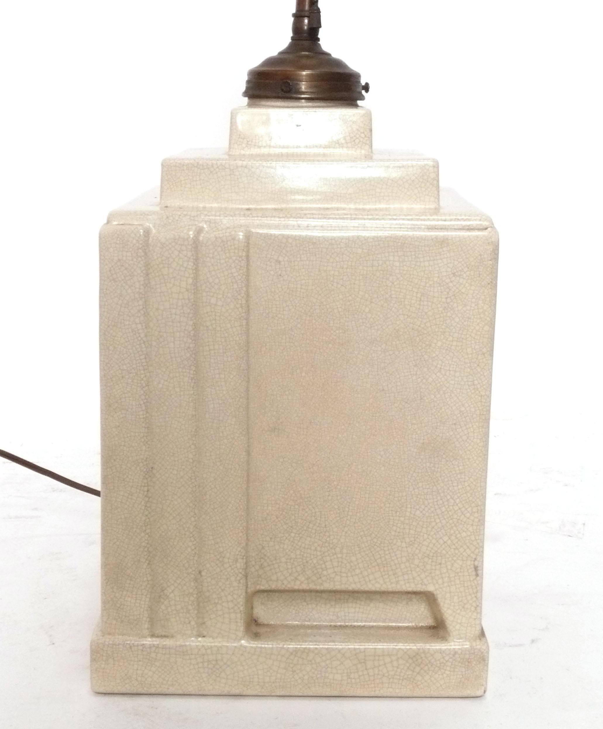 Architectural Art Deco Ceramic Lamp, made by NIMY, Belgium, circa 1930s. Wonderful ivory color with a craquelure glaze. It has been recently rewired and given a new lamp shade, and it is ready to use. The height to the top of the socket is 22