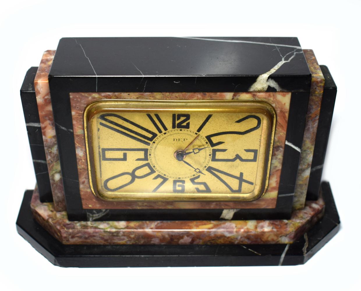 Very striking 1930s Art Deco French clock by Dep. The case is solid multi-colored marble, the bezel and face are in gold tone metal. Very iconic Art Deco stretched numerals. This clock is a really cute size and ideal as a bedroom clock or side