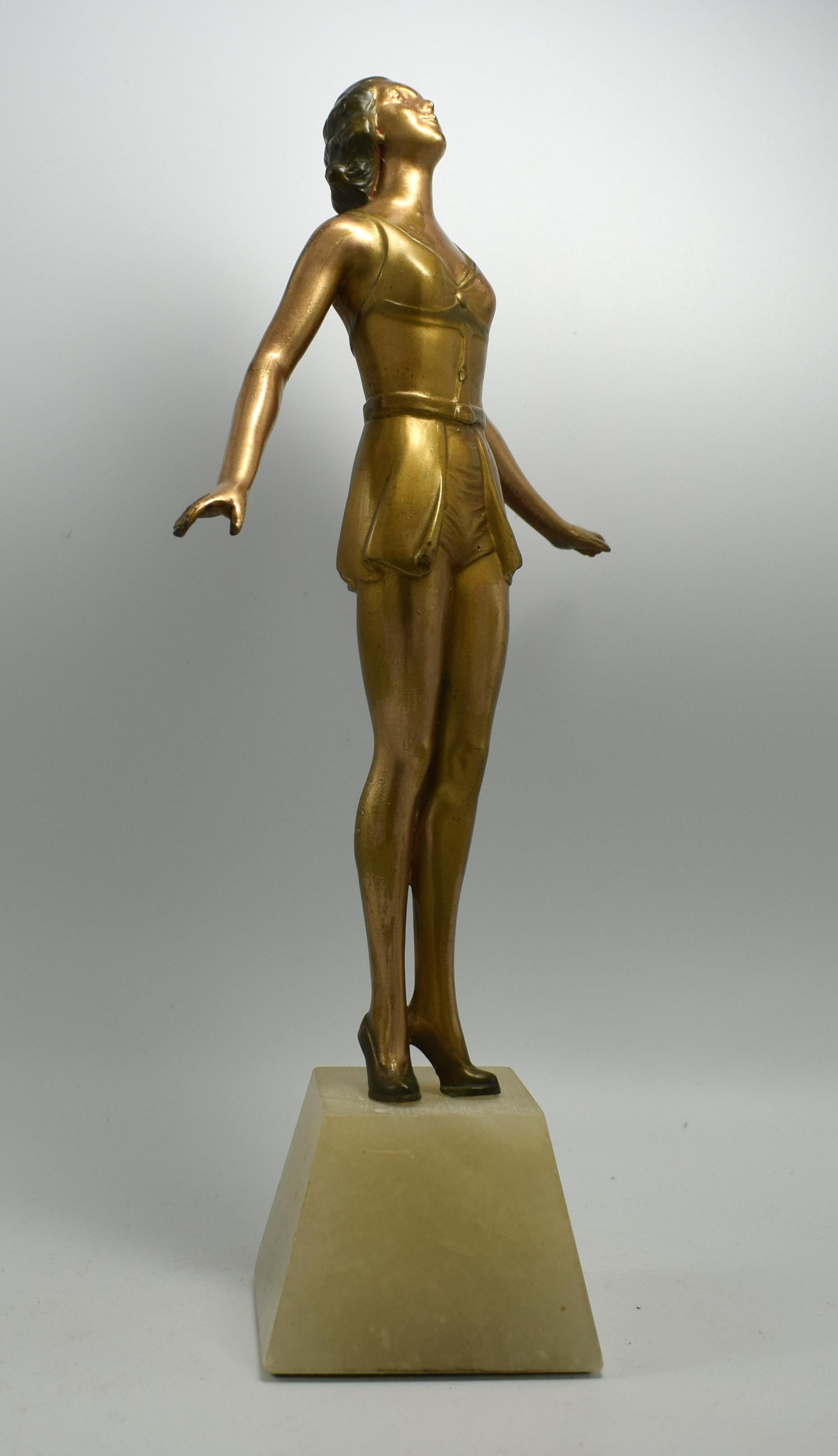 A very elegant and original, 1930s Art Deco figurine of a lady in cold painted Spelter. She stands on an alabaster base which is in good order and free from any damage. There are no breaks or repairs just some minor losses to the cold painted