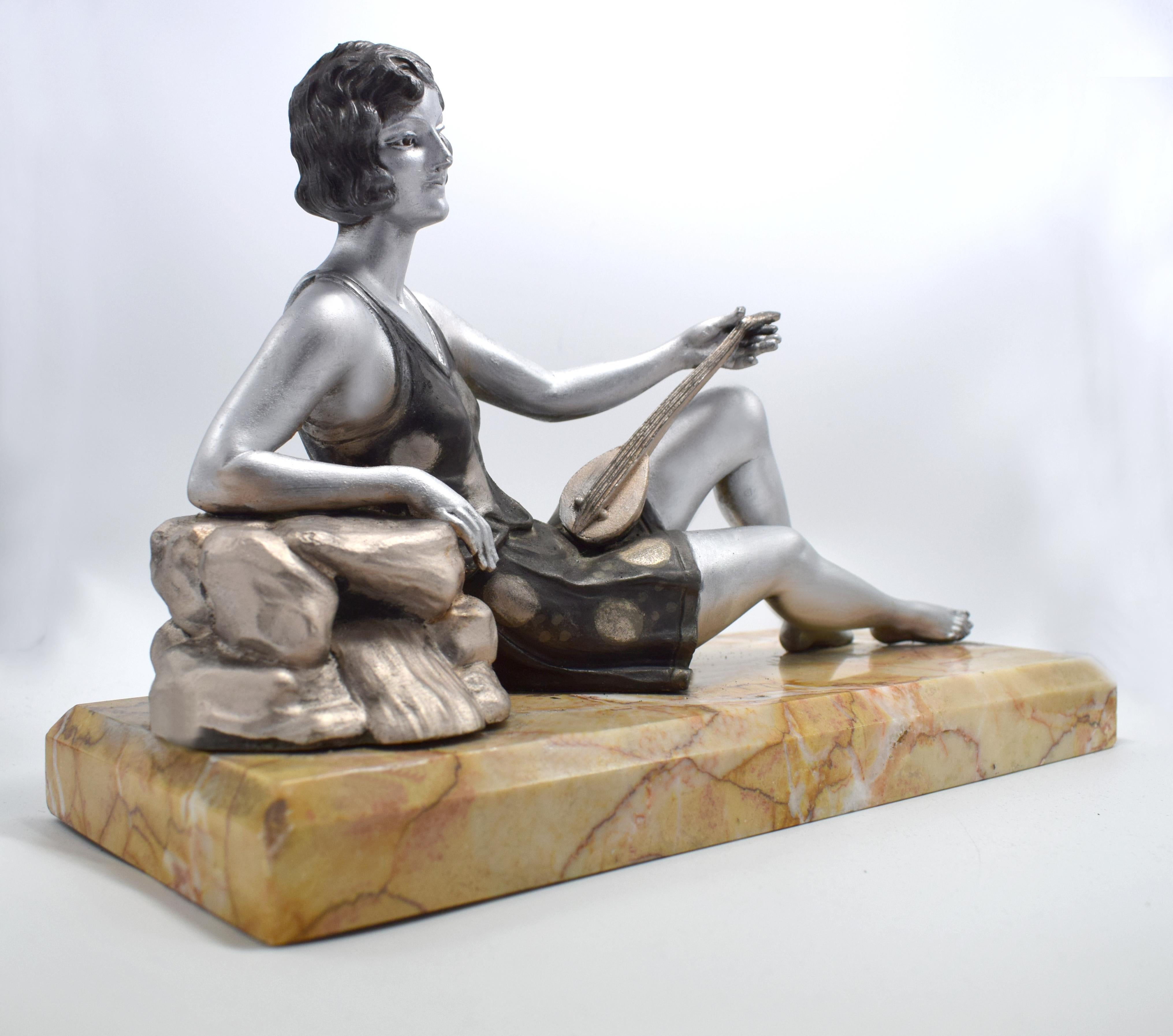 For your consideration is this totally authentic 1930s French spelter female figure reclining on a rock with a lute. The base metal is spelter also known as white metal and cold painted on top. Lovely detailing, styled in the fashion of the day with
