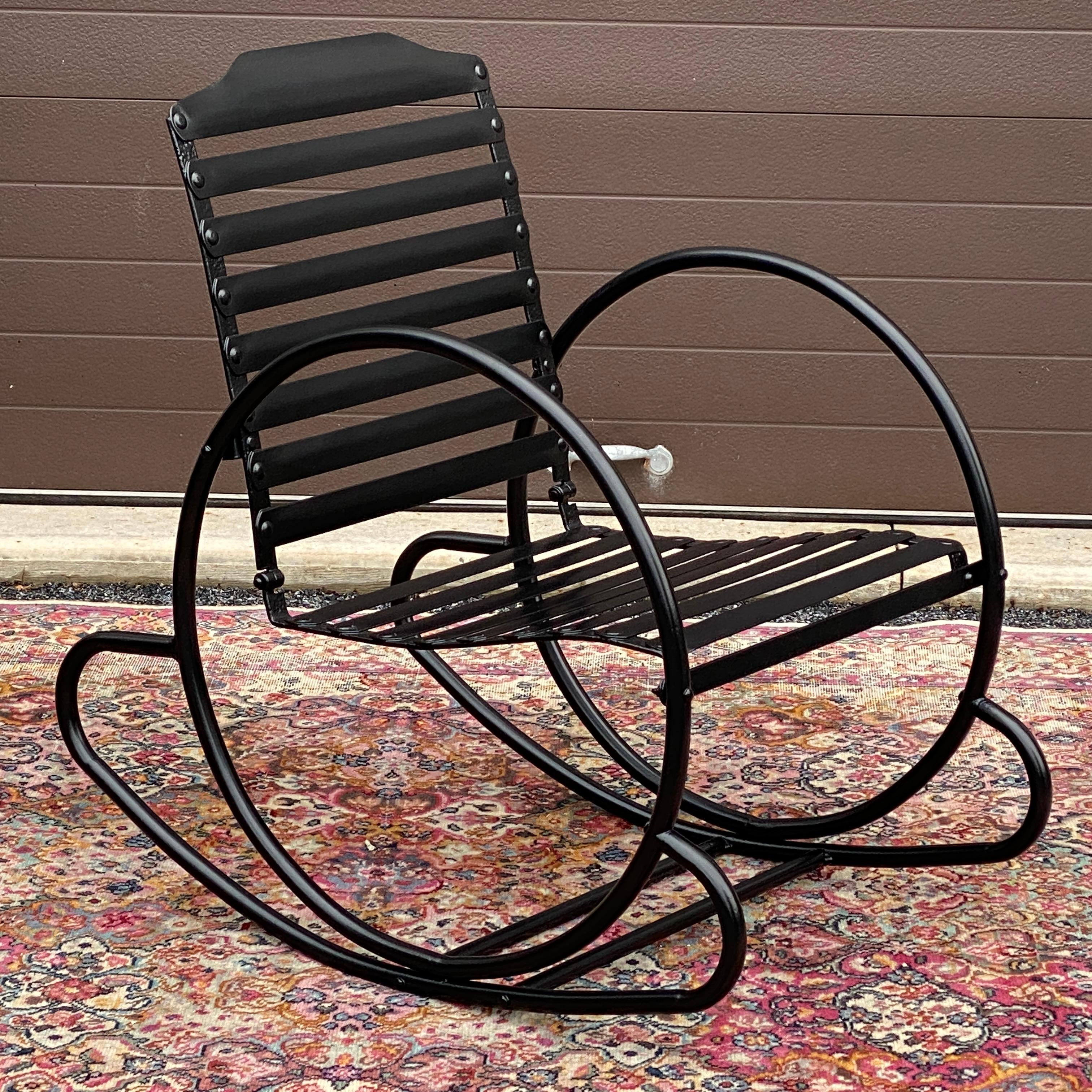 An amazing and rare streamlined American Art Deco tubular rocking chair having circular hoop sides, slat backs and seats with heavy steel or iron construction throughout. Suitable for indoors or outdoor use! Circa 1930 unmarked. We had this chair