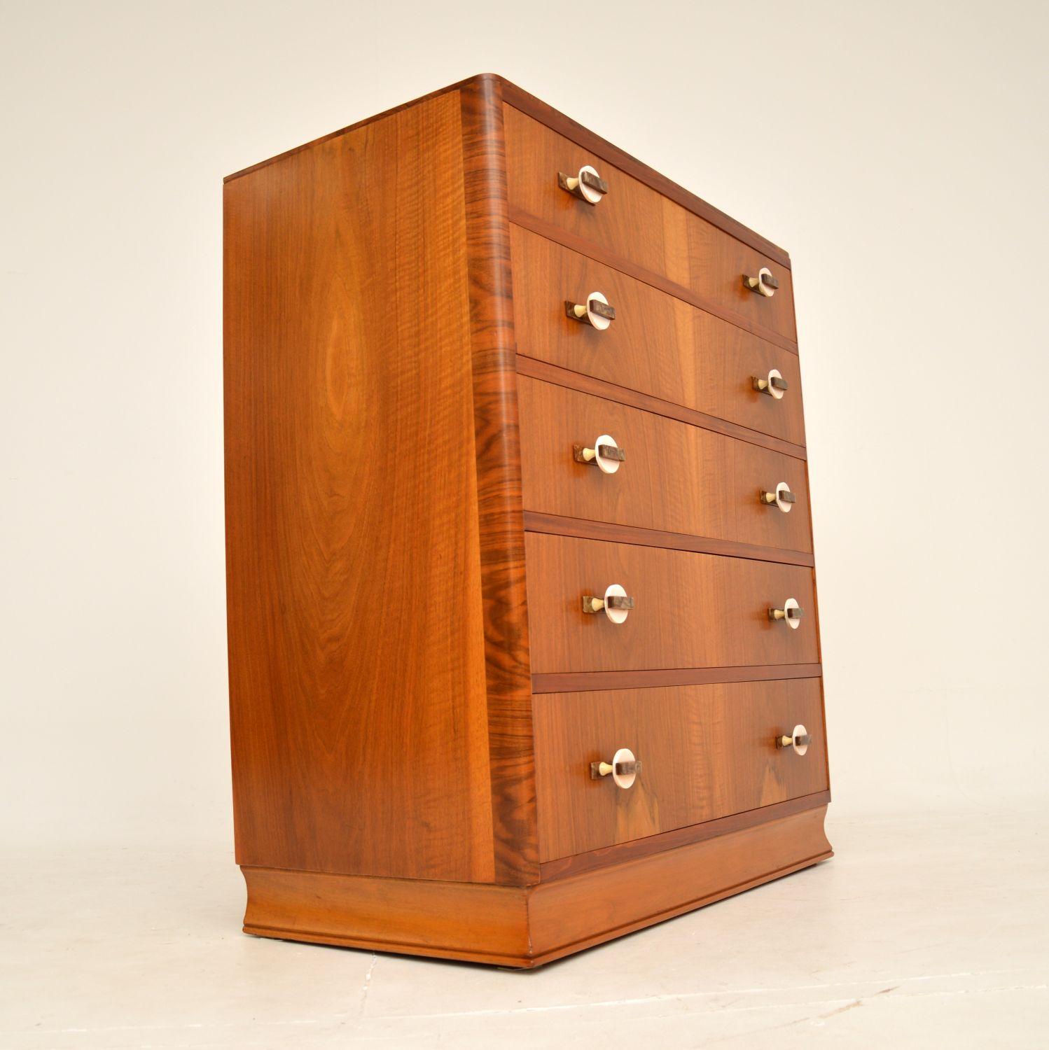 A beautiful original Art Deco period chest of drawers in walnut. This was made in England, it dates from the 1930’s.

It has a gorgeous and very useful design, with lots of storage space. The walnut has a lovely colour and striking grain patterns,