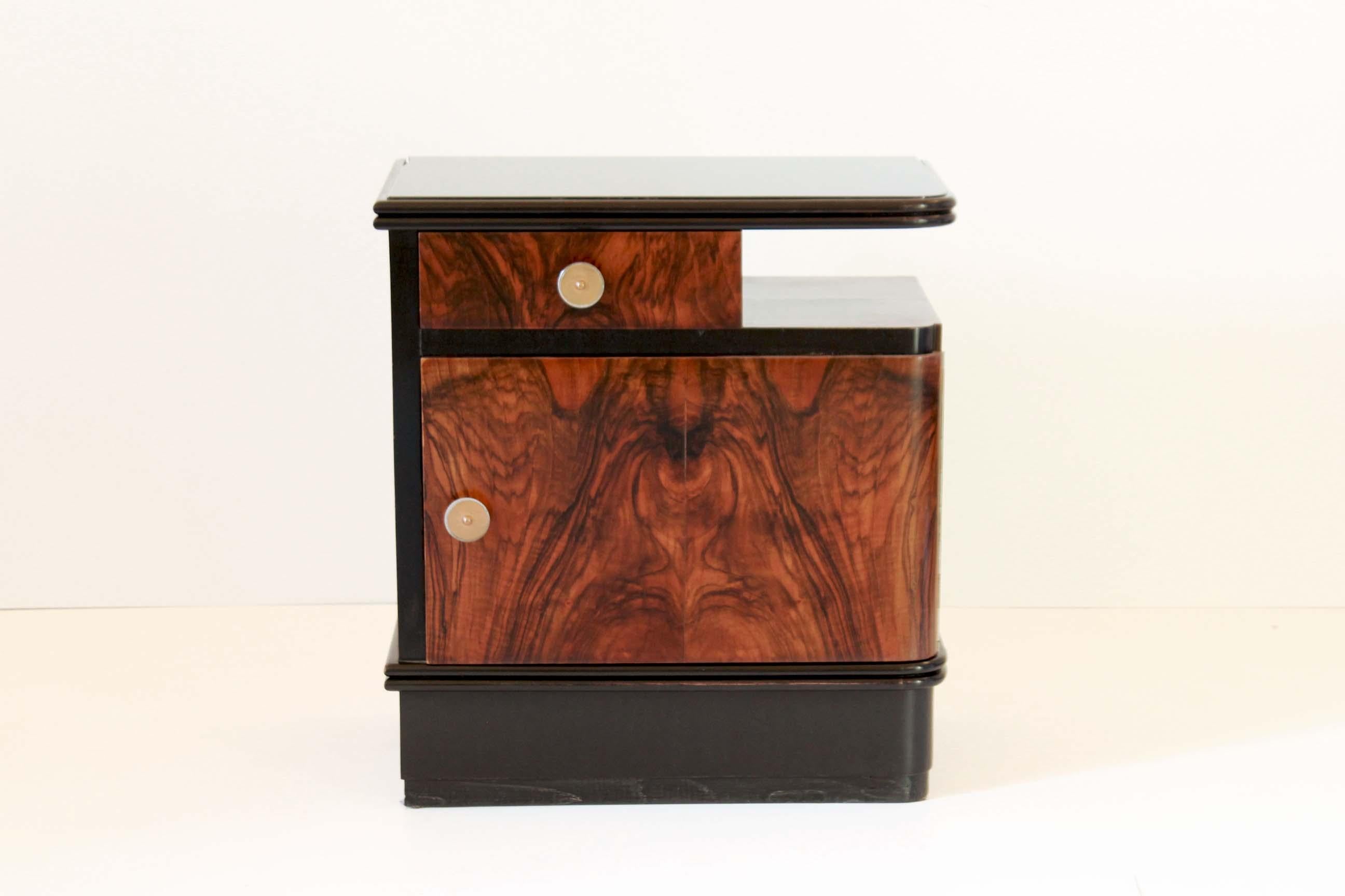 A rare pair of 1930s Art Deco night stands with black opaline top and wood structure. 

The items have been fully restored. In very good conditions with only few signs of time.