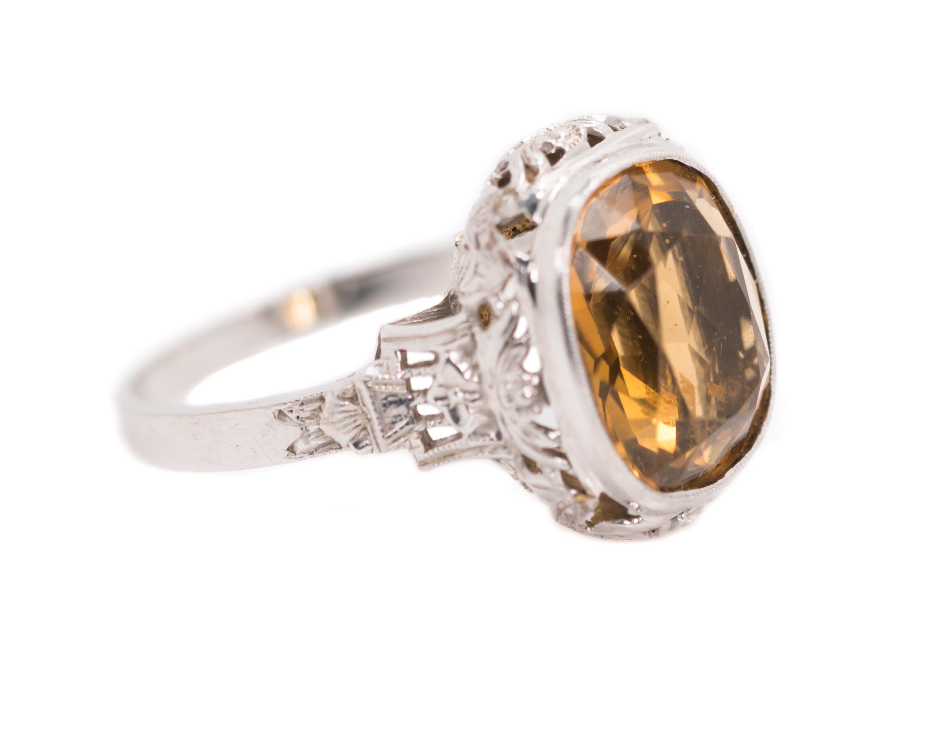 Art Nouveau 5.0 Carat Citrine Ring - 14K White Gold, Citrine

Features:
5.0 Carat, Old European, Antique Cushion cut Citrine
14 Karat White Gold Filigree Setting
Cathedral Setting with Open Shoulders and Gallery
Citrine is Bezel set with a fine