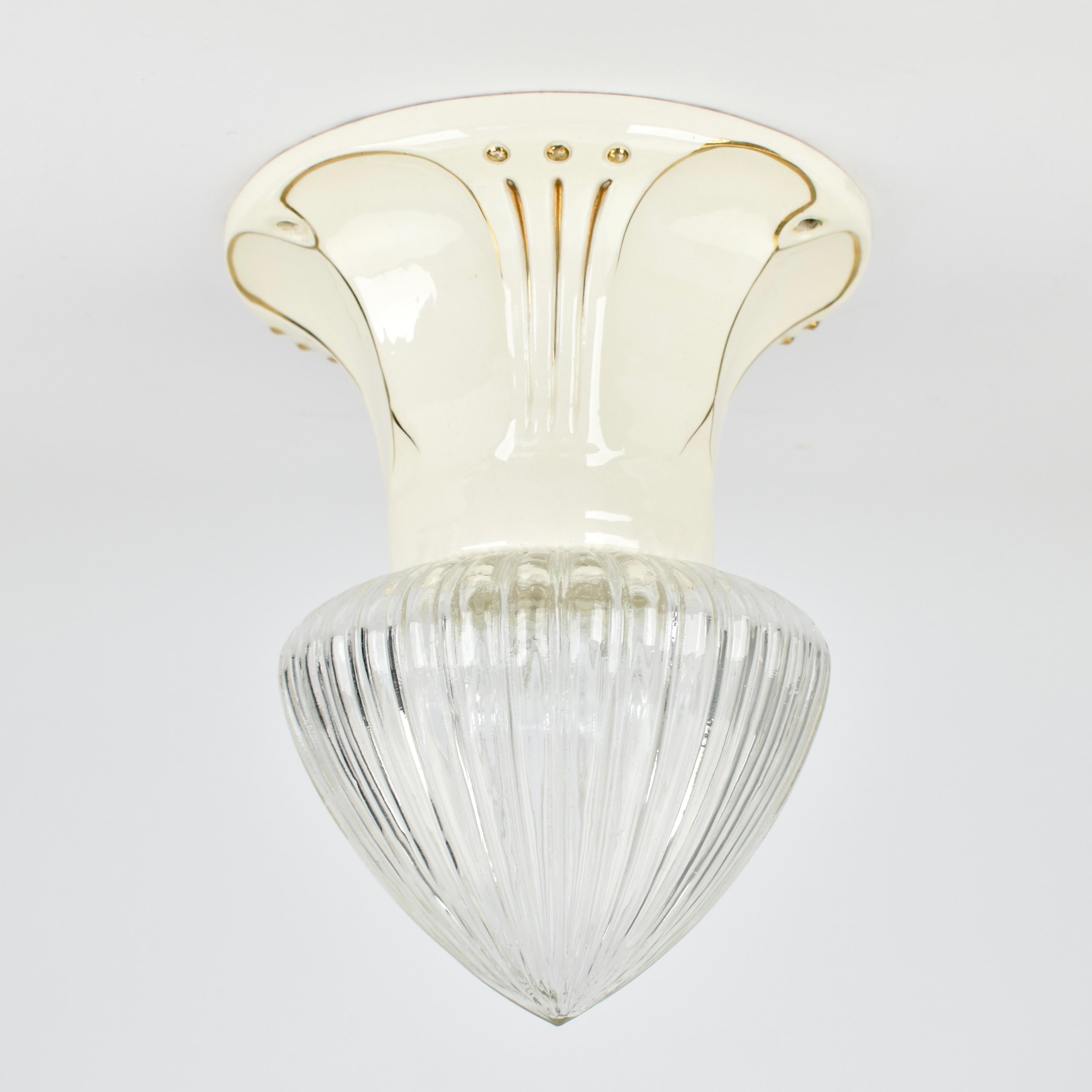 Rare 1930s art nouveau flush mount light fixture by Julius Dressler (JBD), Austria. Featuring a beautifully glazed ceramic base in a soft cream/off-white hue with exquisite gold Art Nouveau-style decorations, this piece embodies the luxurious