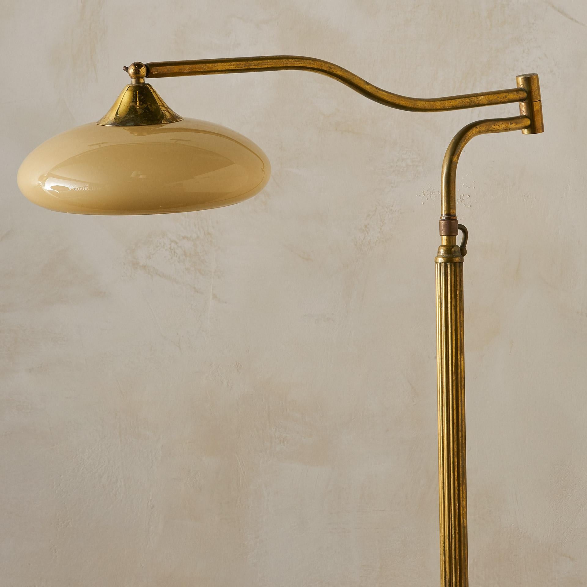 An antique brass floor lamps featuring an adjustable swing arm and a gorgeous creamy opaline glass shade.

 