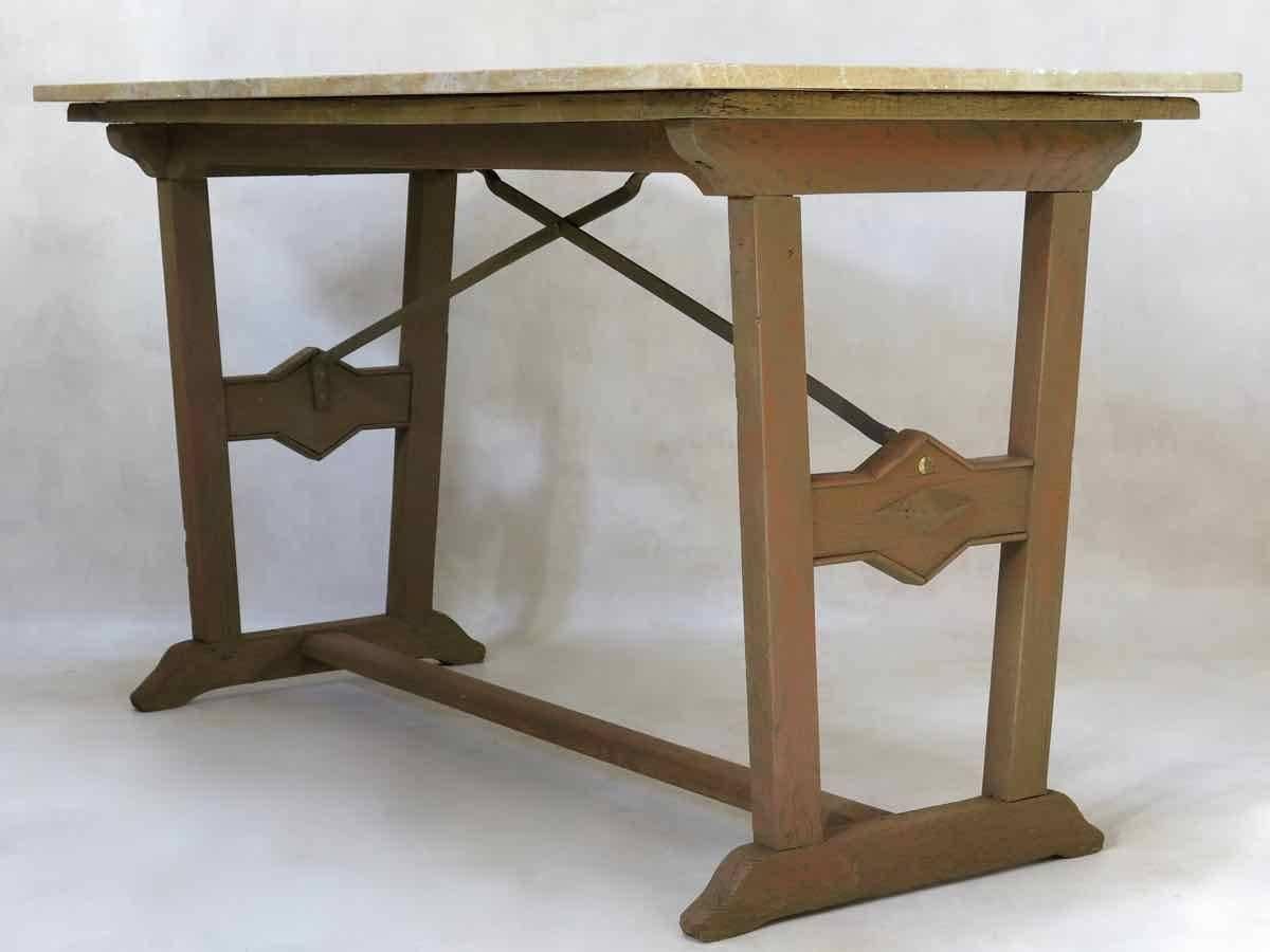 Unusual bistrot style table with an oak and iron base, topped with a thick slab of yellow marble. The uprights taper in towards the base and are decorated with a diamond-shaped design. Original, distressed brown paint on the wood.